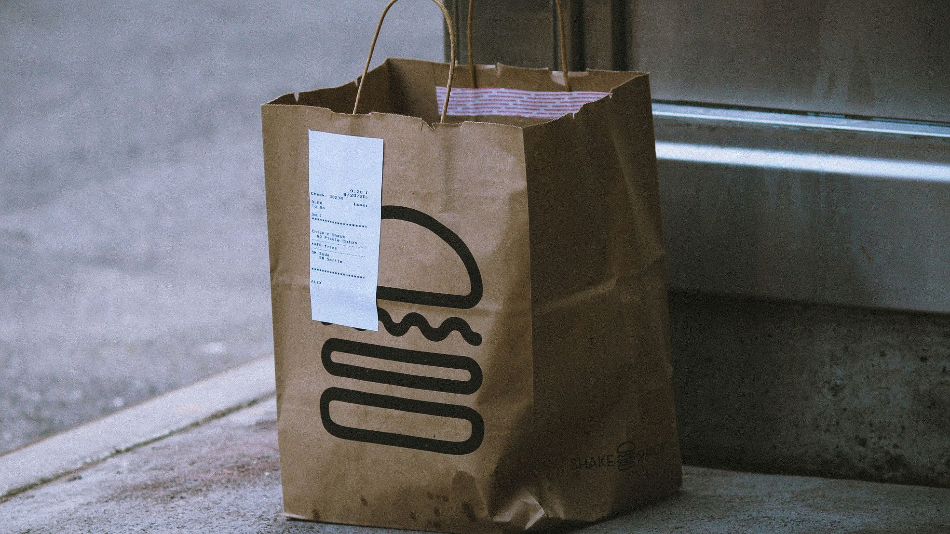 brown paper bag on gray concrete floor