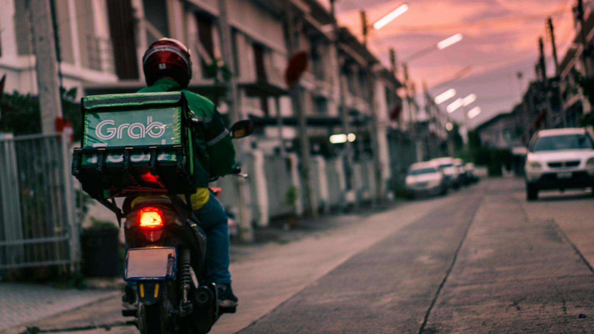a person riding a motorcycle down a street
