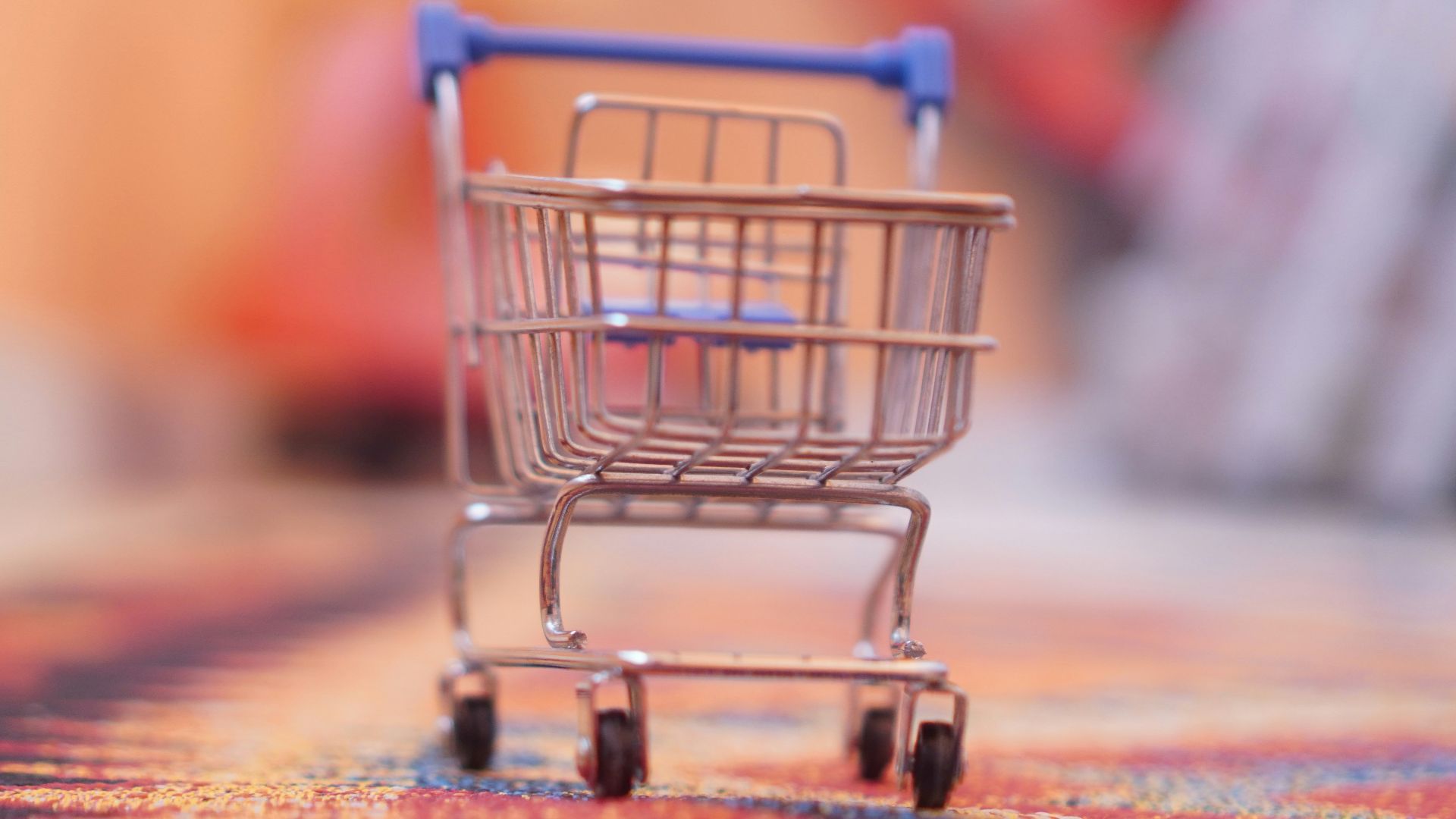 a miniature shopping cart sitting on top of a rug