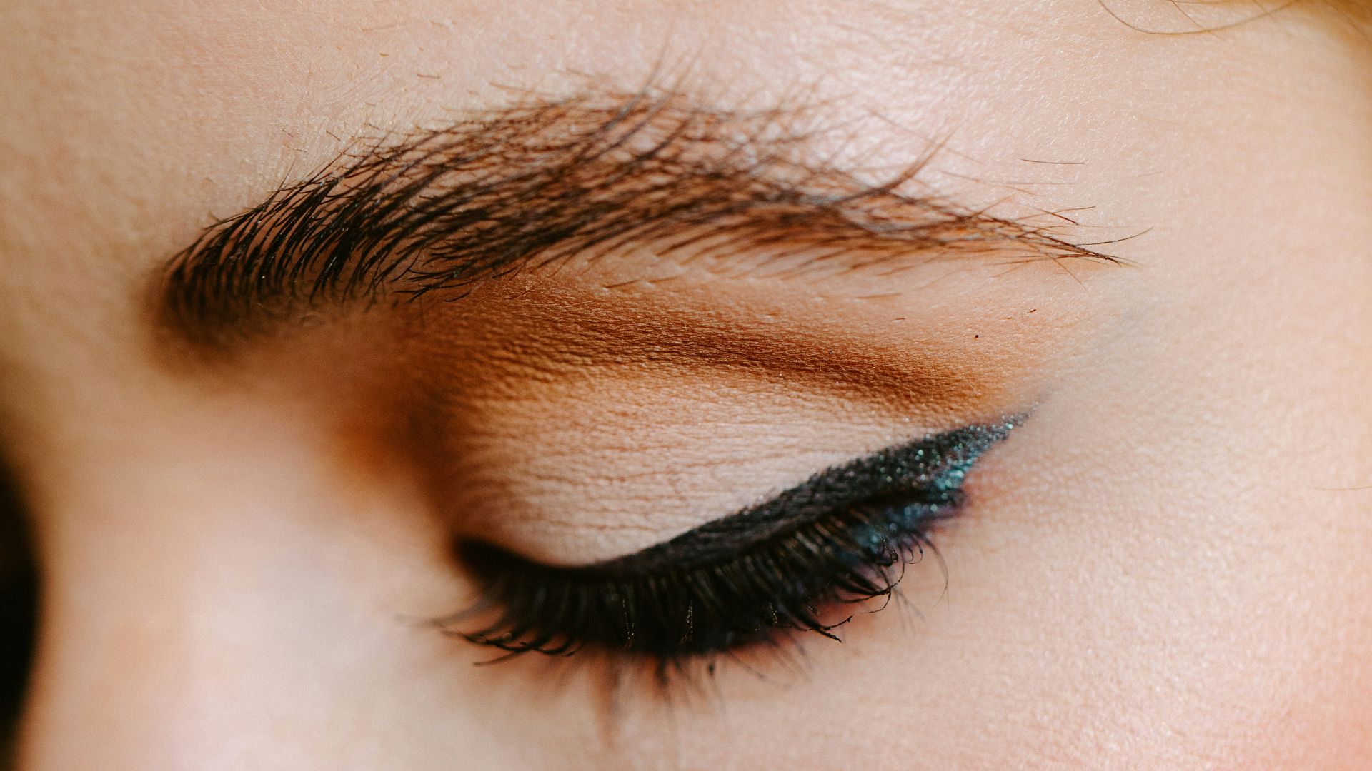 woman with red lipstick and black mascara