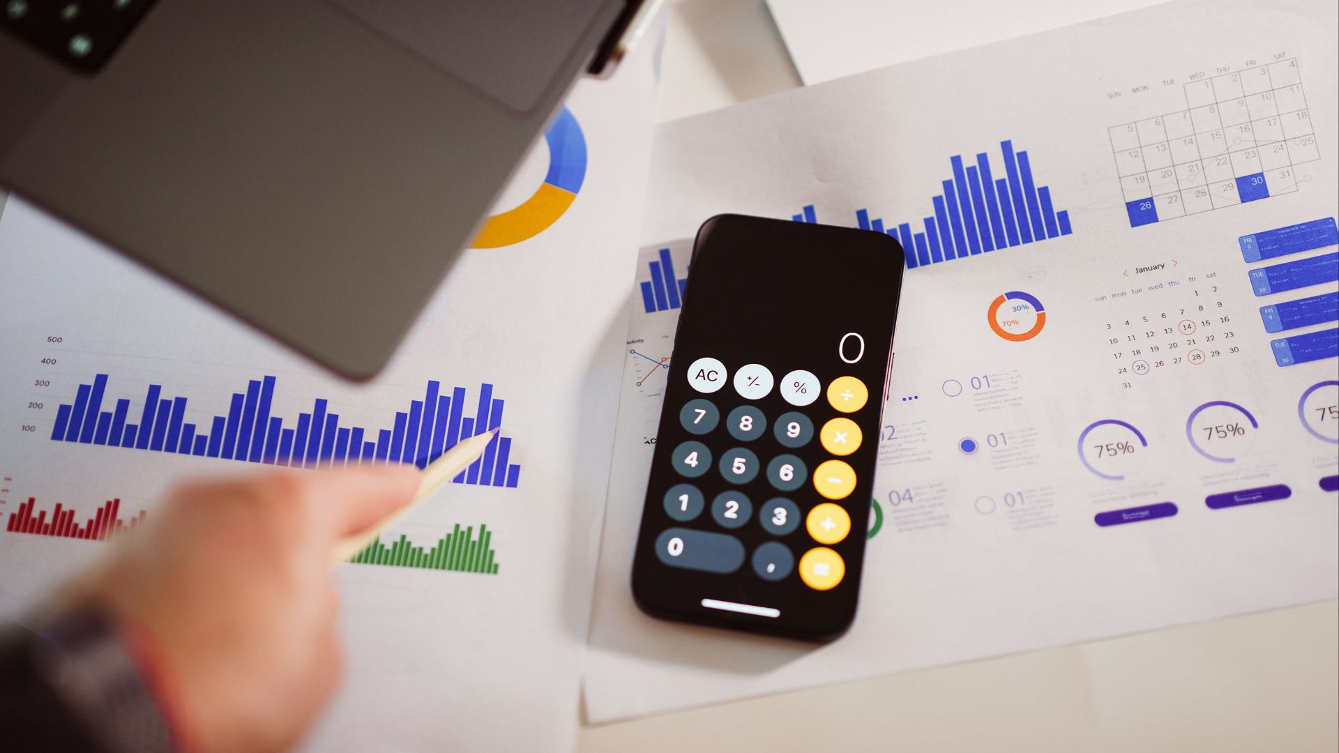 a calculator sitting on top of a table next to a laptop