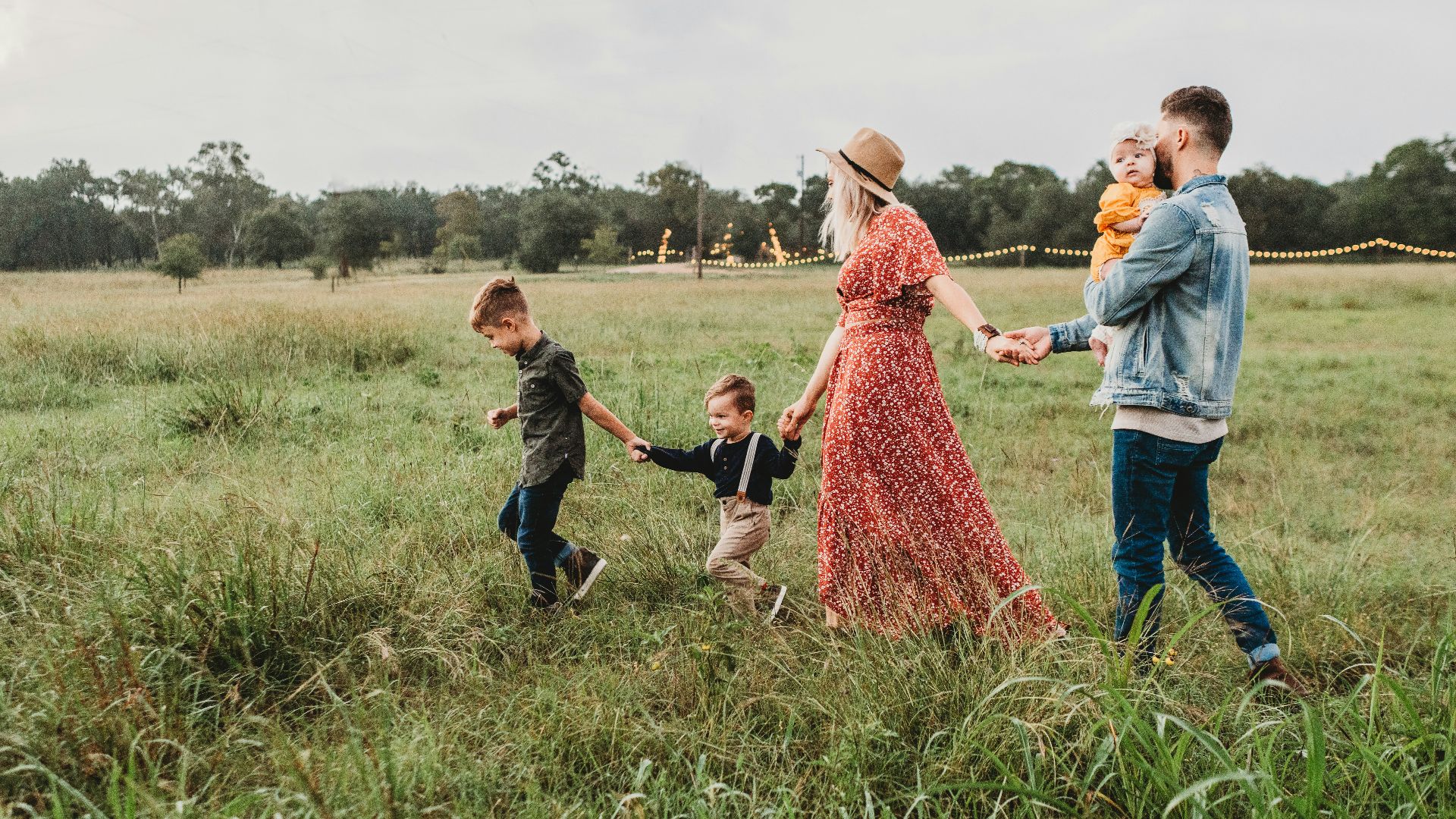woman holding man and toddler hands during daytime