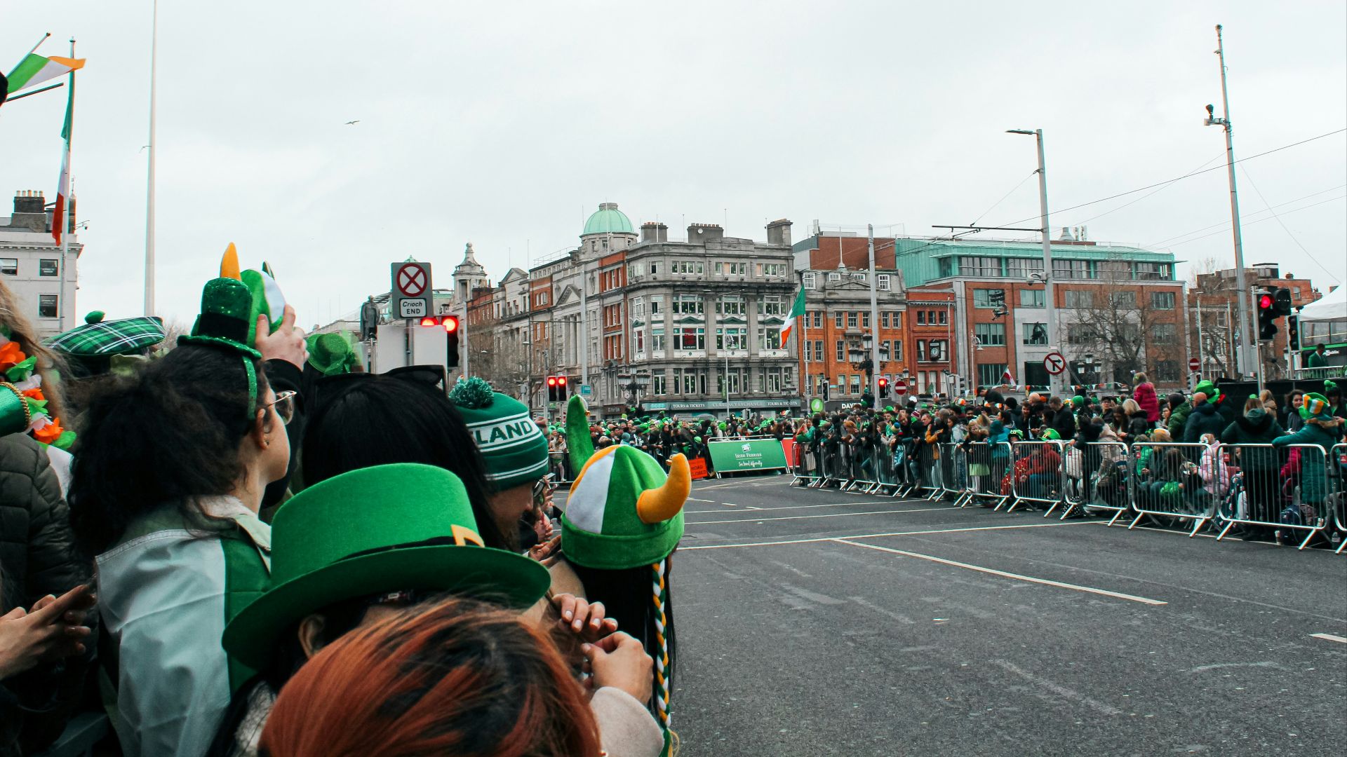 a group of people standing on the side of a road