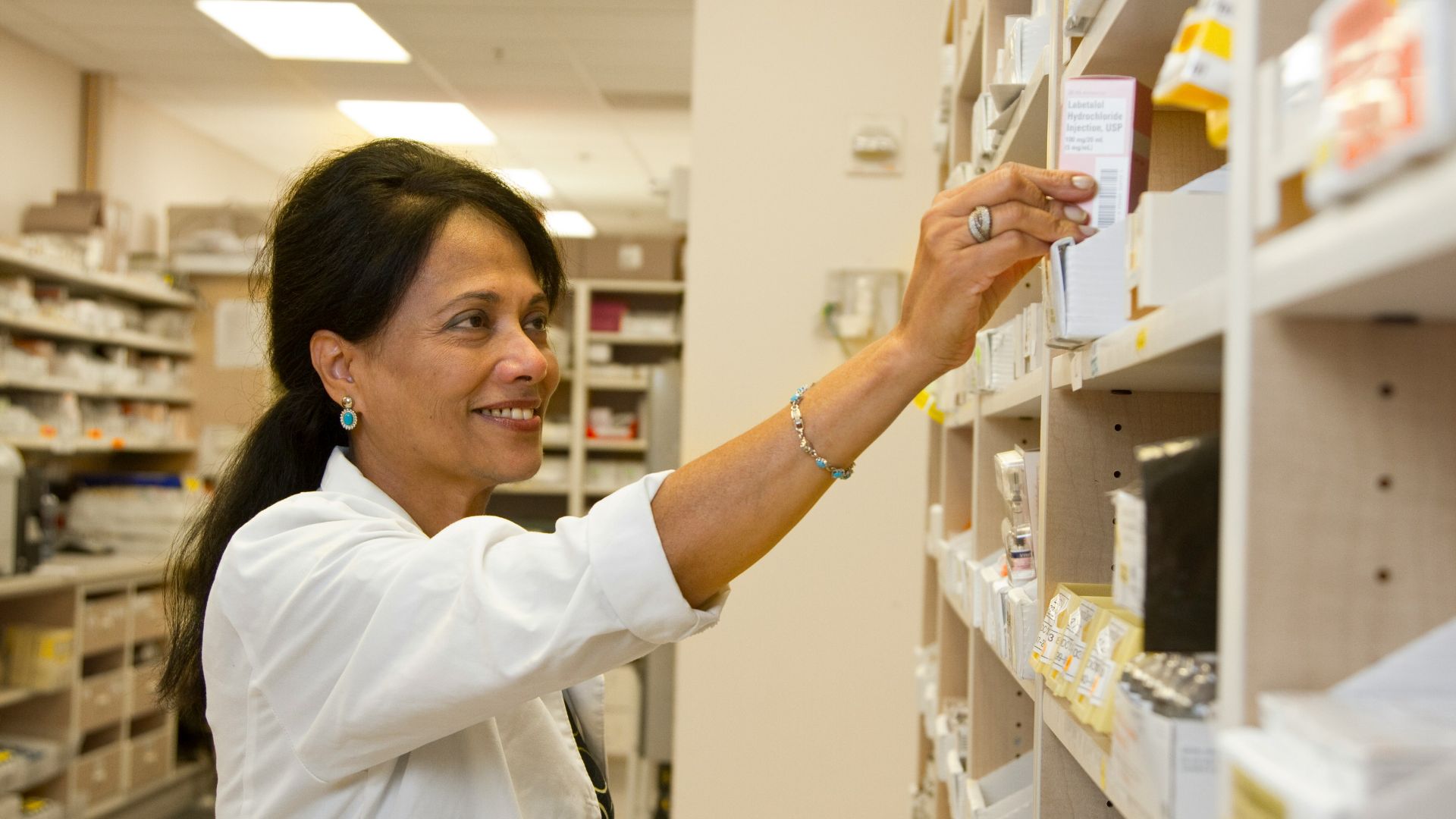 man in white dress shirt holding white box