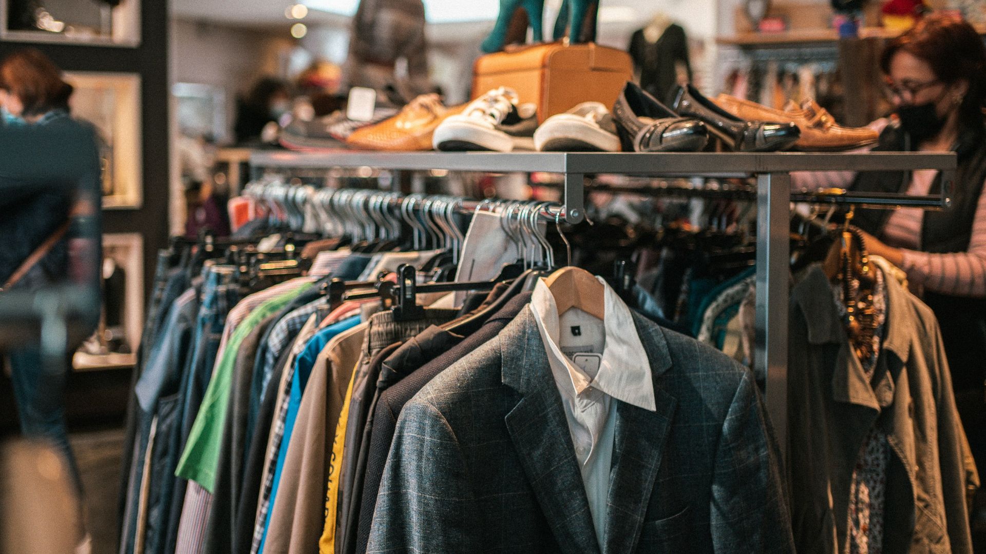 a rack of clothes and shoes in a store
