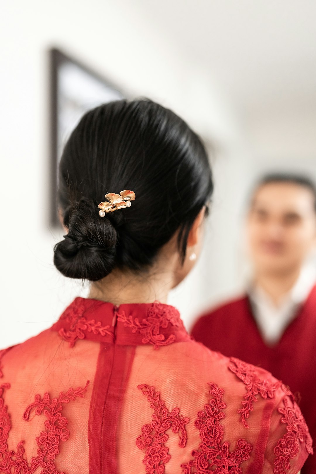 a woman in a red dress with a flower in her hair
