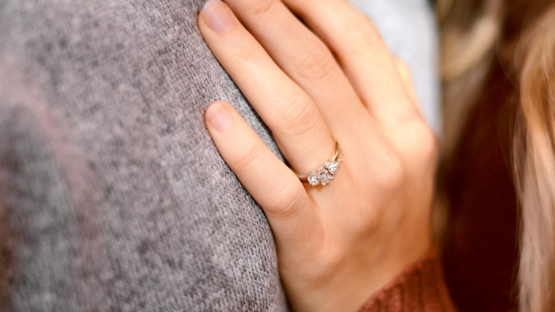 woman leaning on person in gray top