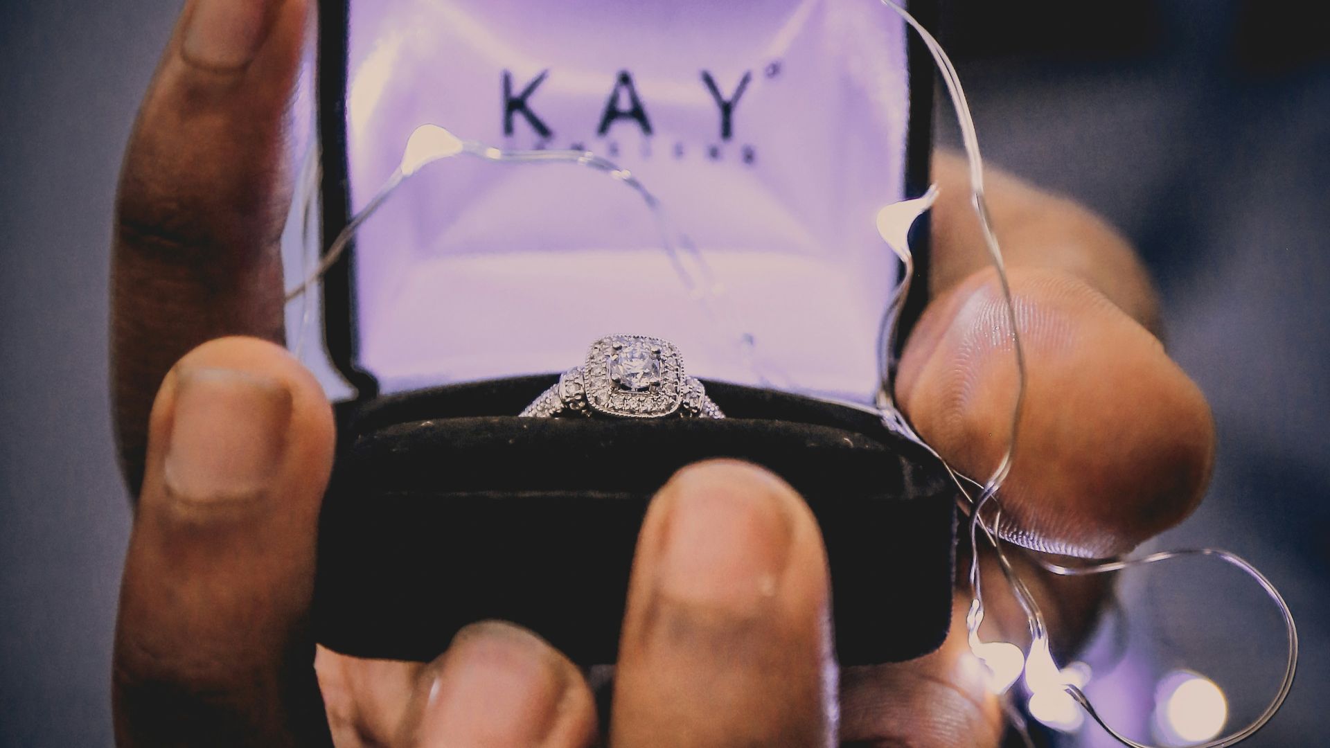 person holding silver-colored ring