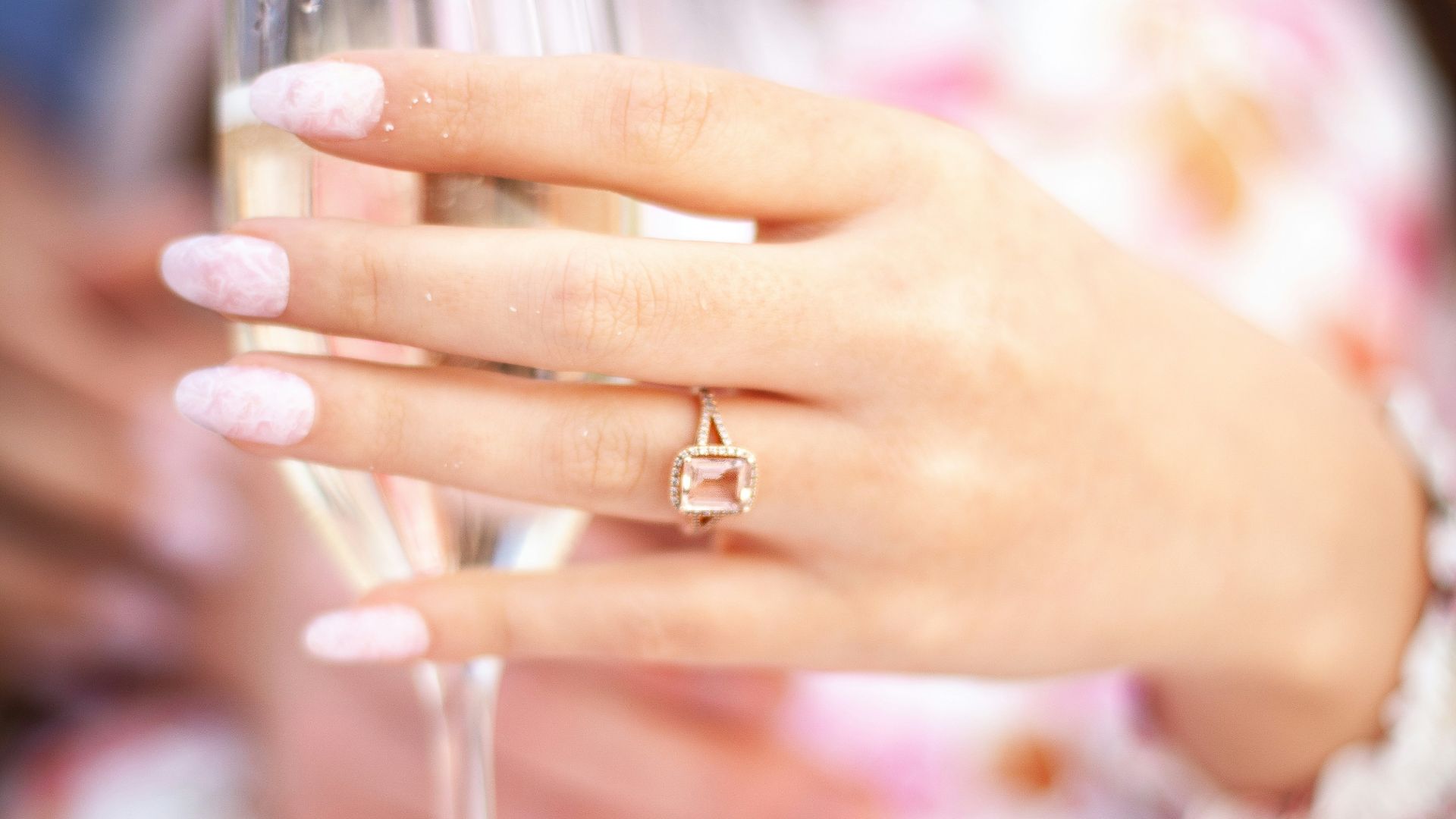 a close up of a person holding a wine glass