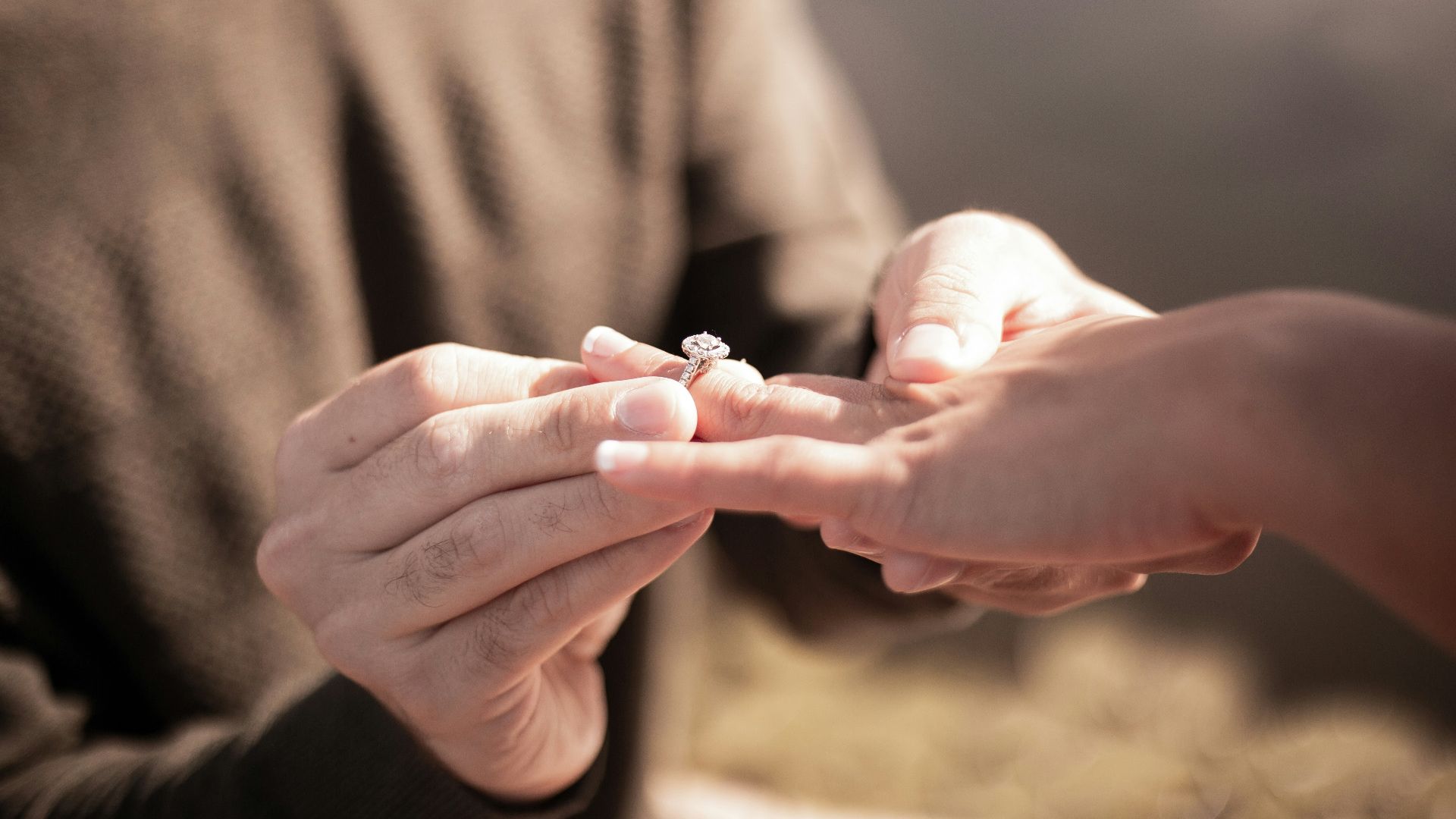 person holding silver diamond ring