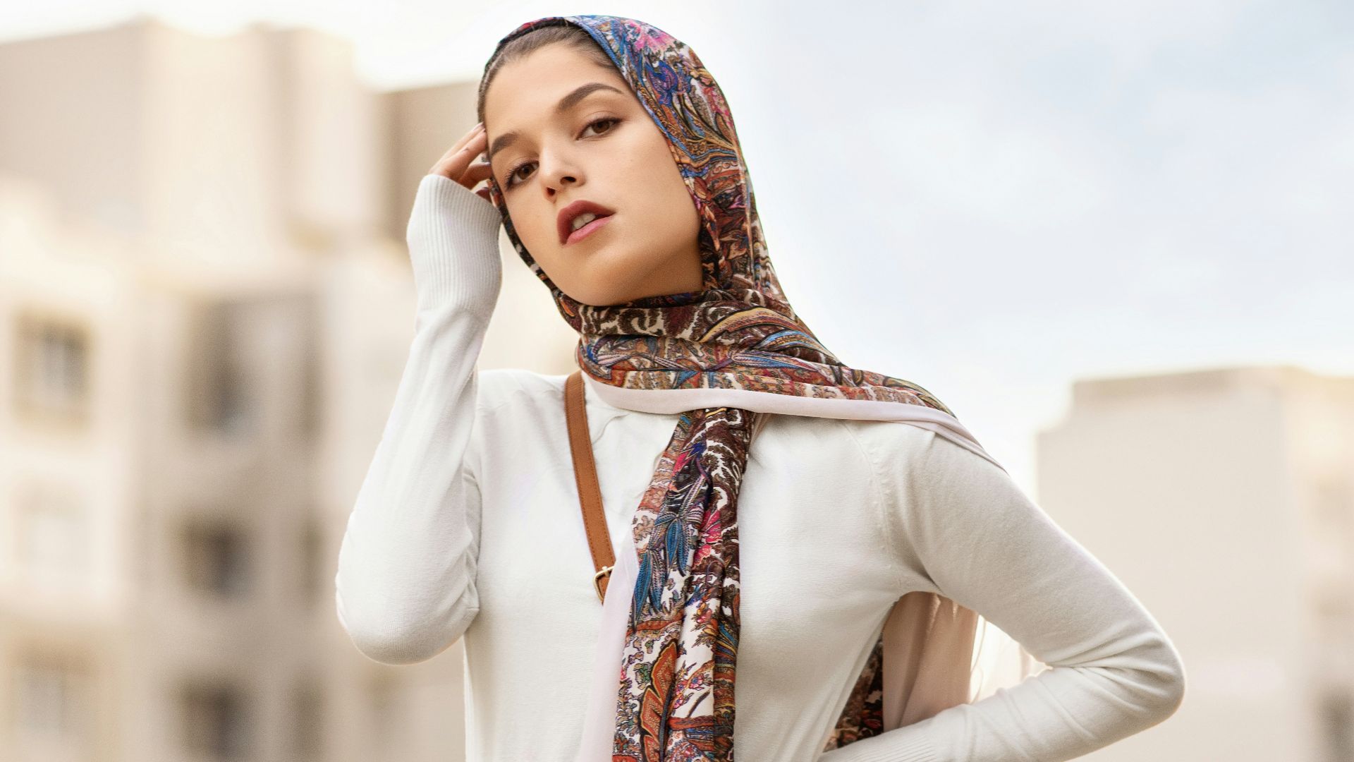woman wearing white long-sleeved top and black pleated skirt