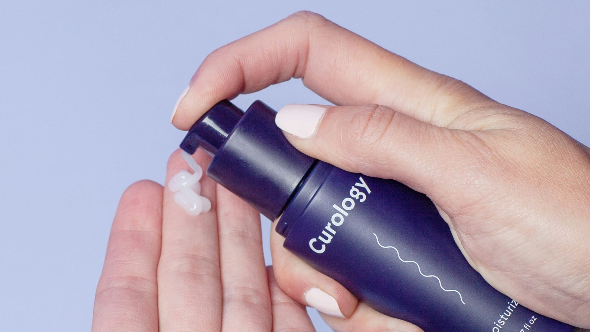 person holding Curology spray bottle