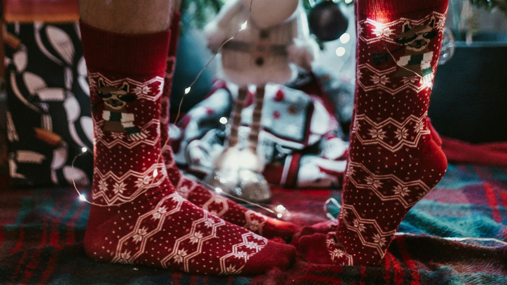 man and woman wearing red-and-white socks standing