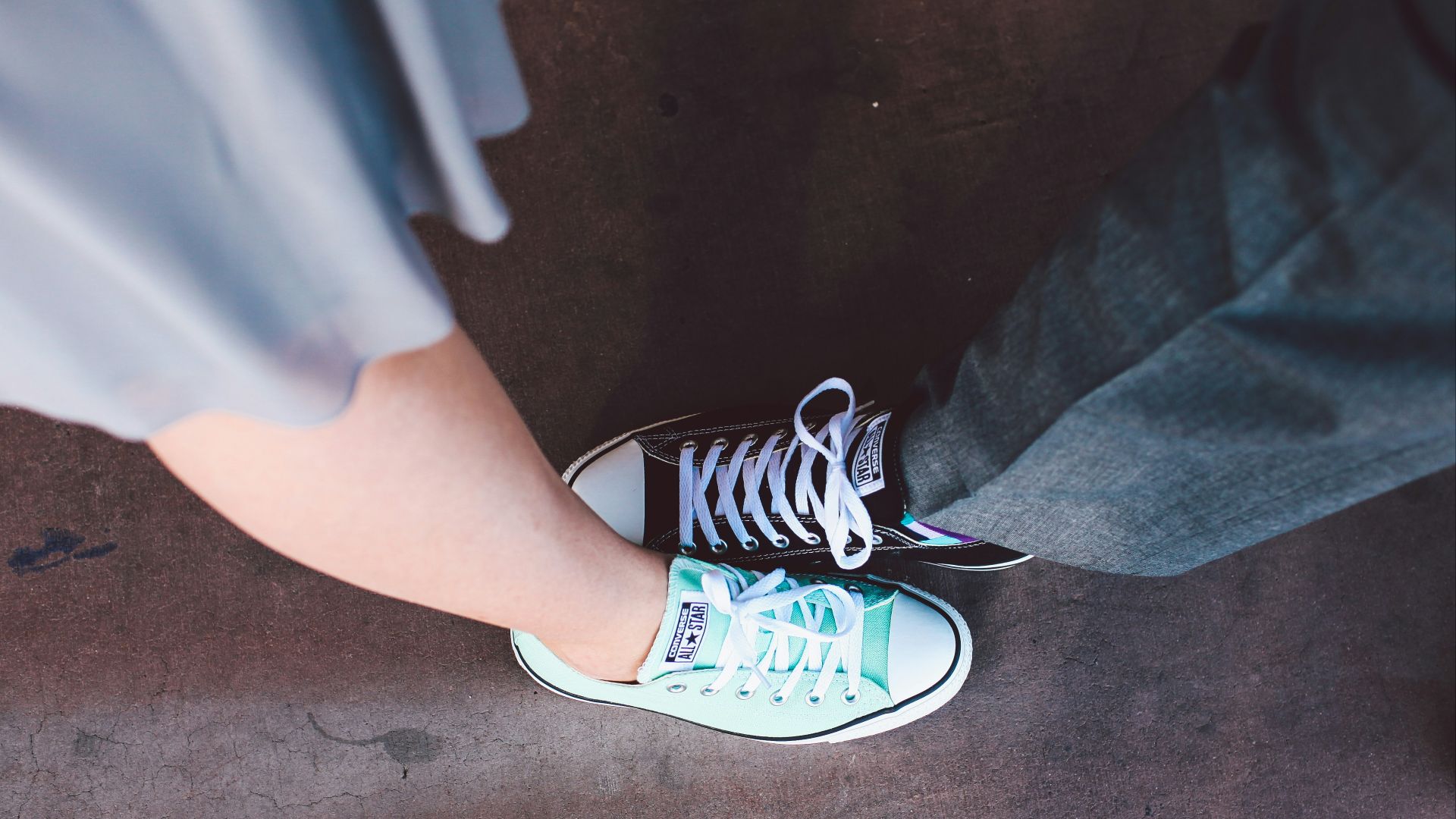 person wearing teal and white Converse All-Star low-top