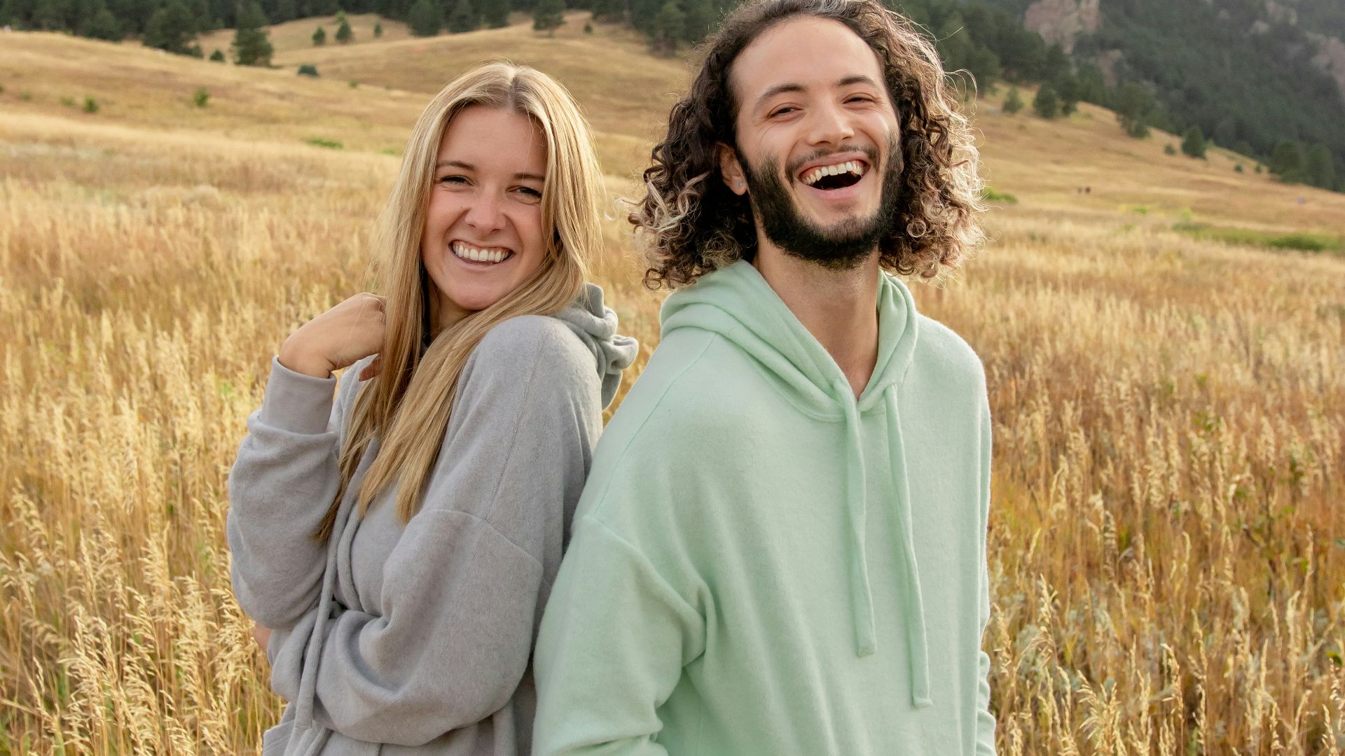 a man and a woman standing in a field