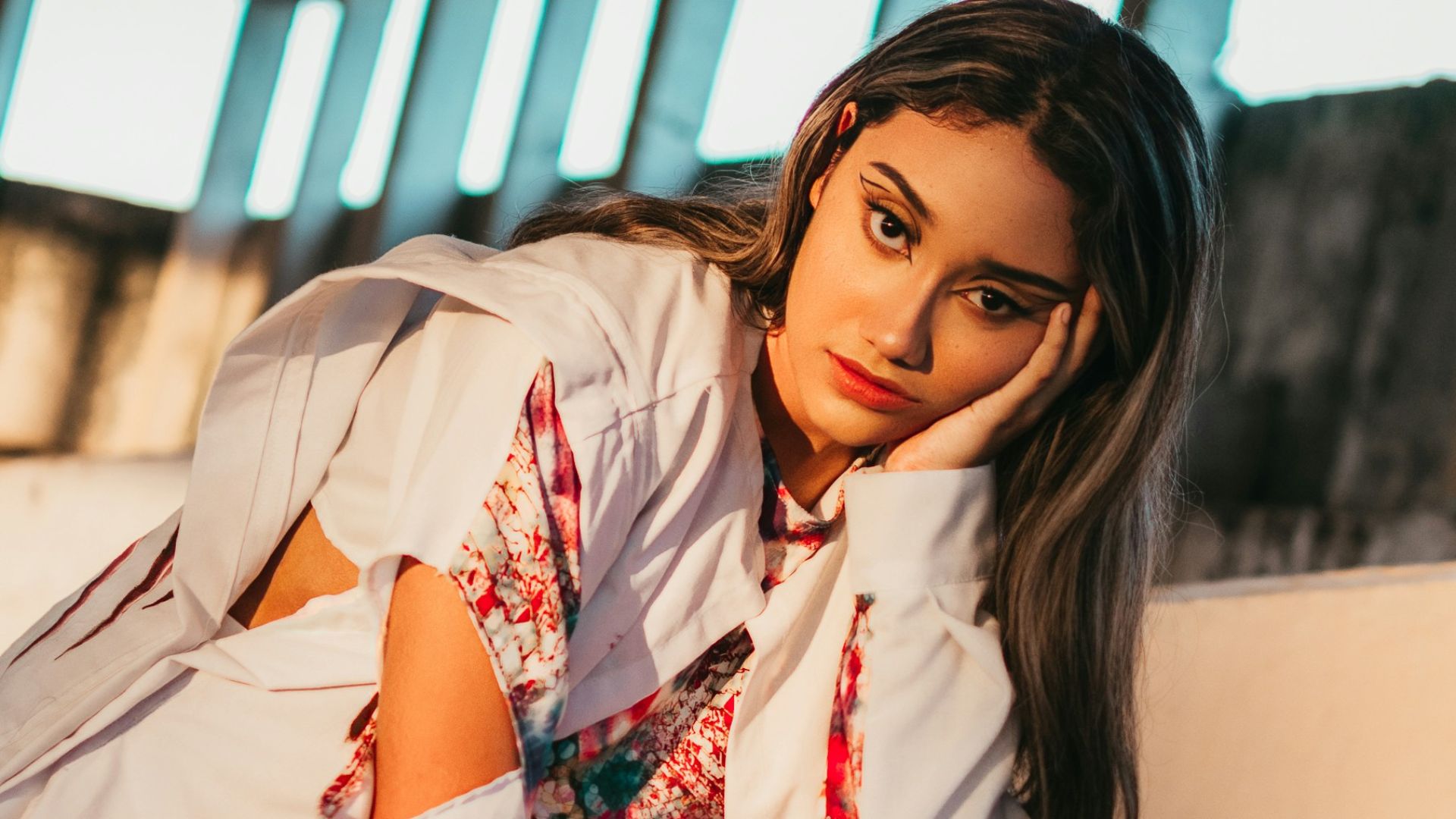 a woman in a white shirt and white pants posing for a picture