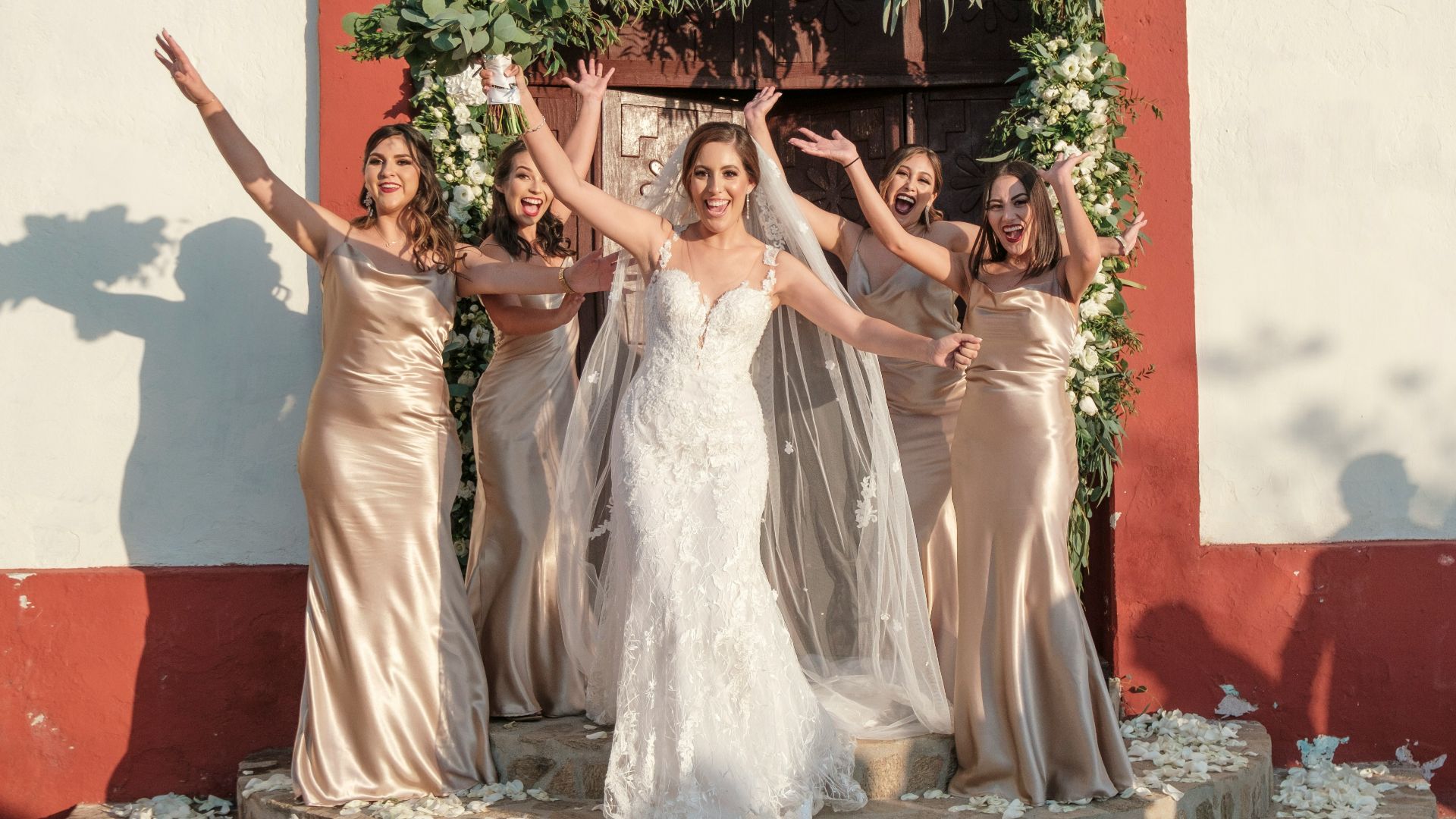 a group of women standing next to each other in front of a building
