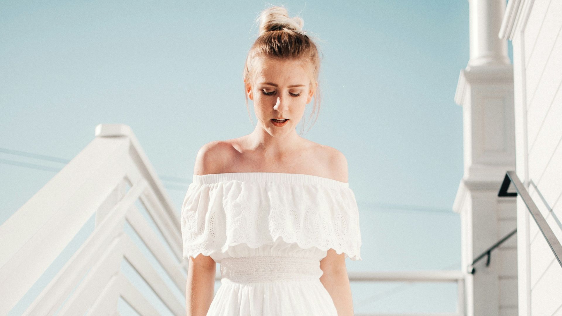 woman walking down stair under clear blue sky during daytime