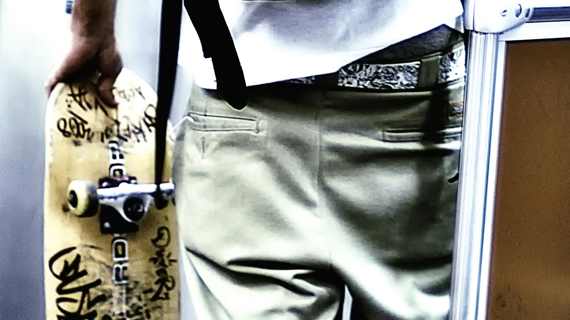 unknown person holding brown skateboard