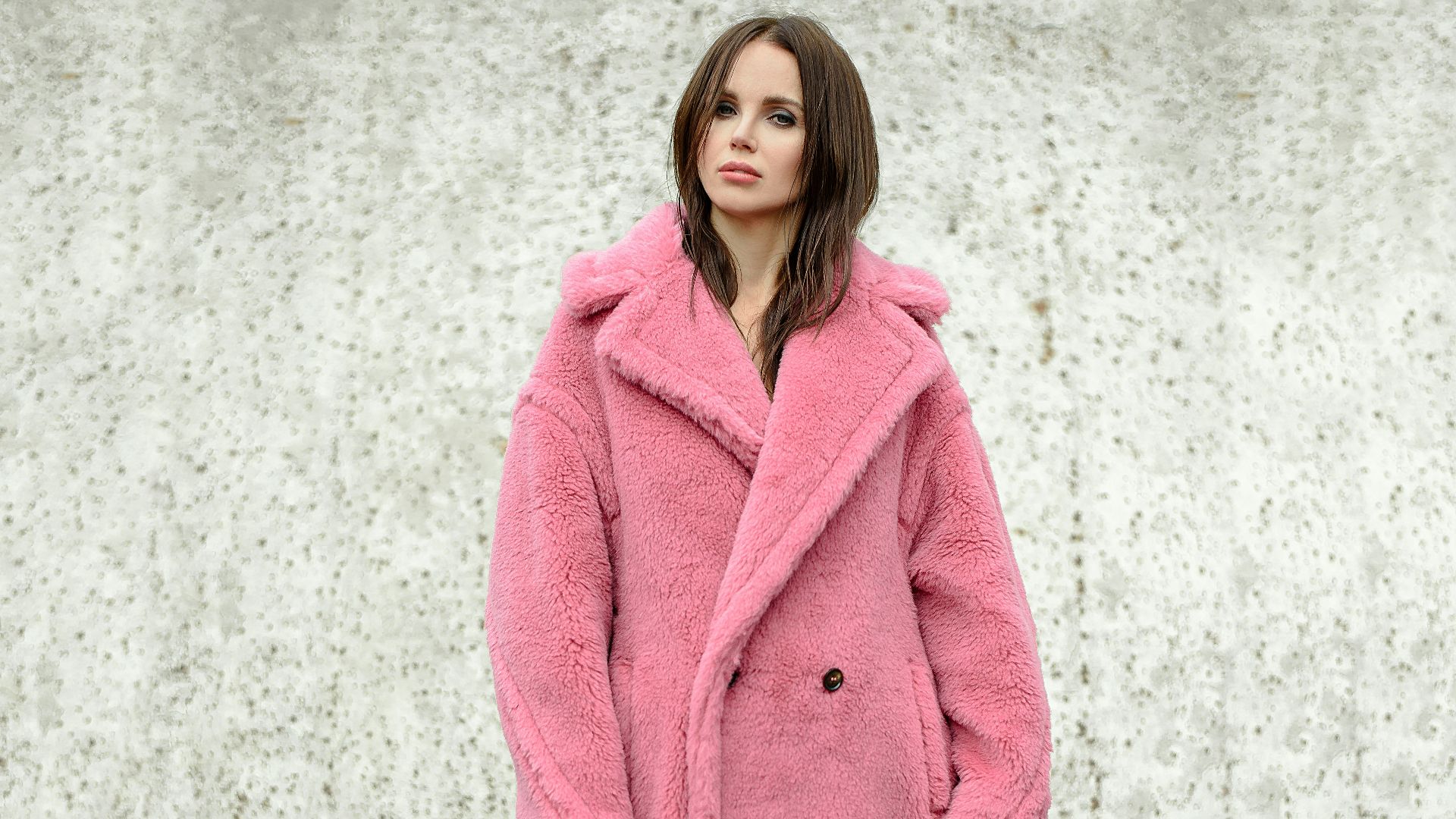 woman standing while wearing pink coat
