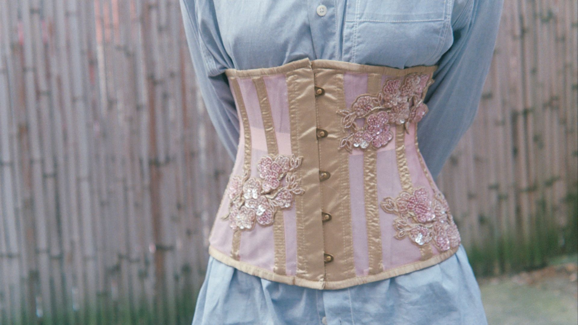 a woman wearing a corset made of fabric
