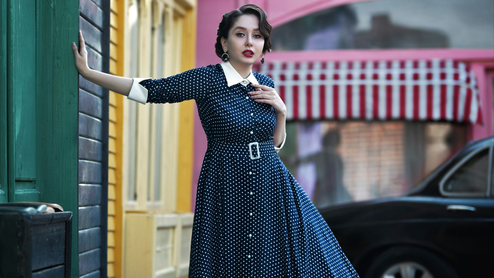 a woman in a blue dress is holding a sign