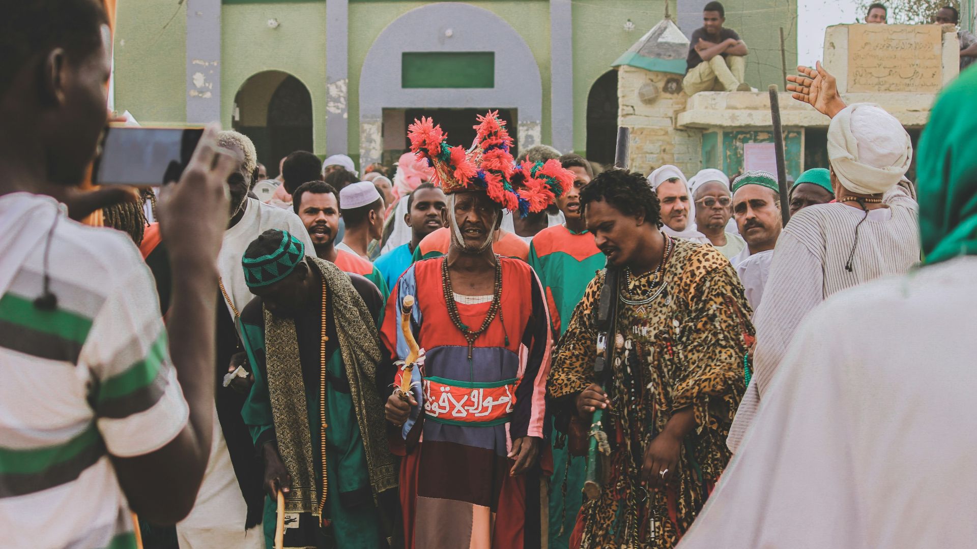 people in traditional dress standing on the street during daytime
