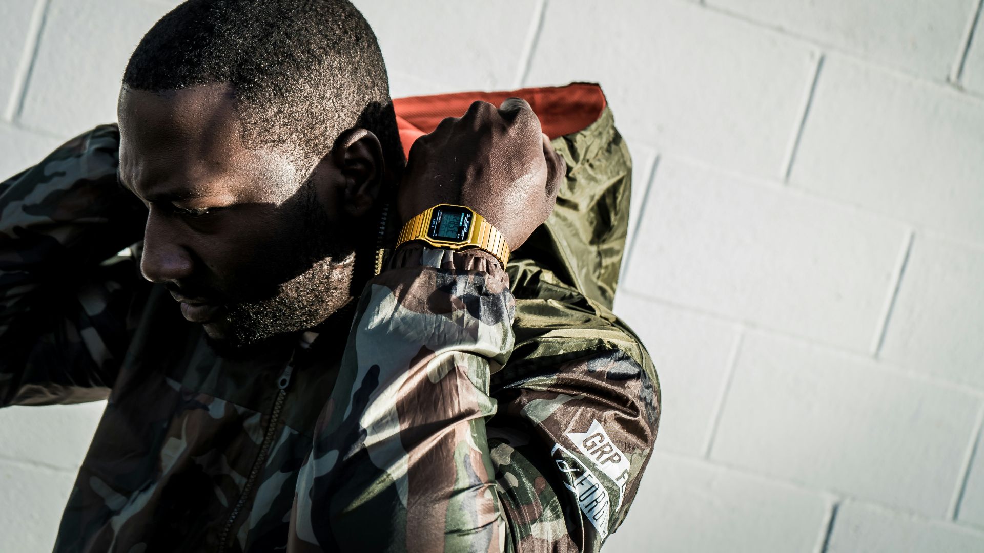 man in green black and white camouflage uniform