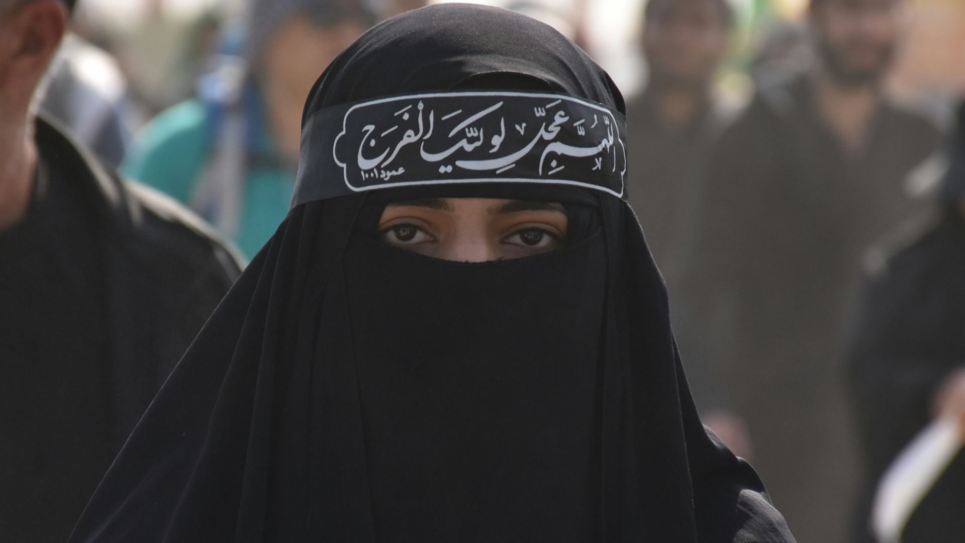 group of people in black walking