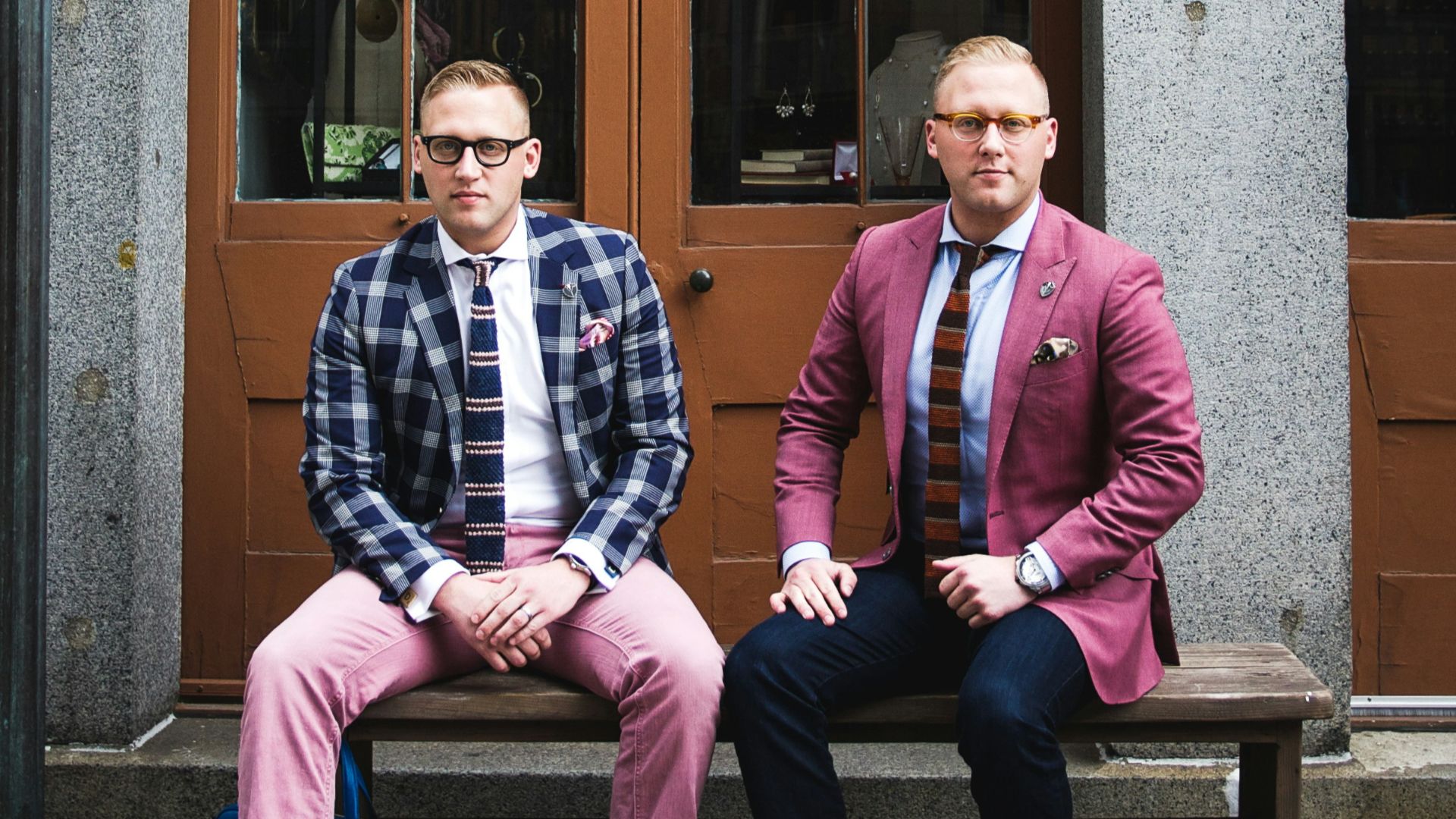 two man in formal suit sitting on bench chair