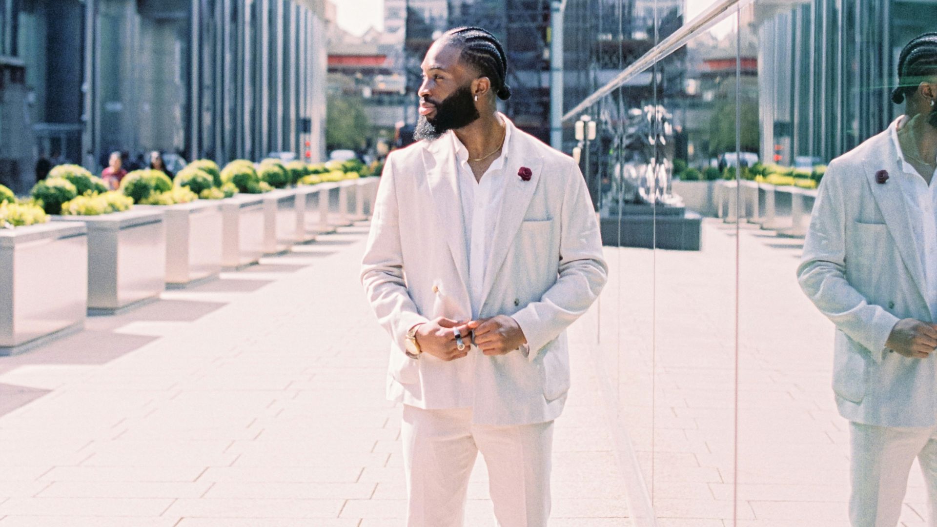 man in white thobe standing on white tiled floor