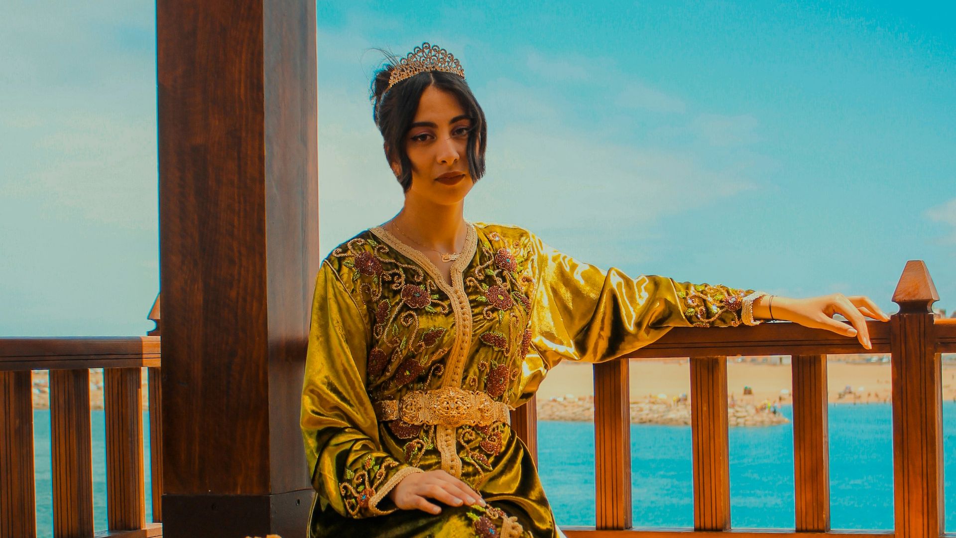 woman in yellow and brown long sleeve dress sitting on brown wooden chair