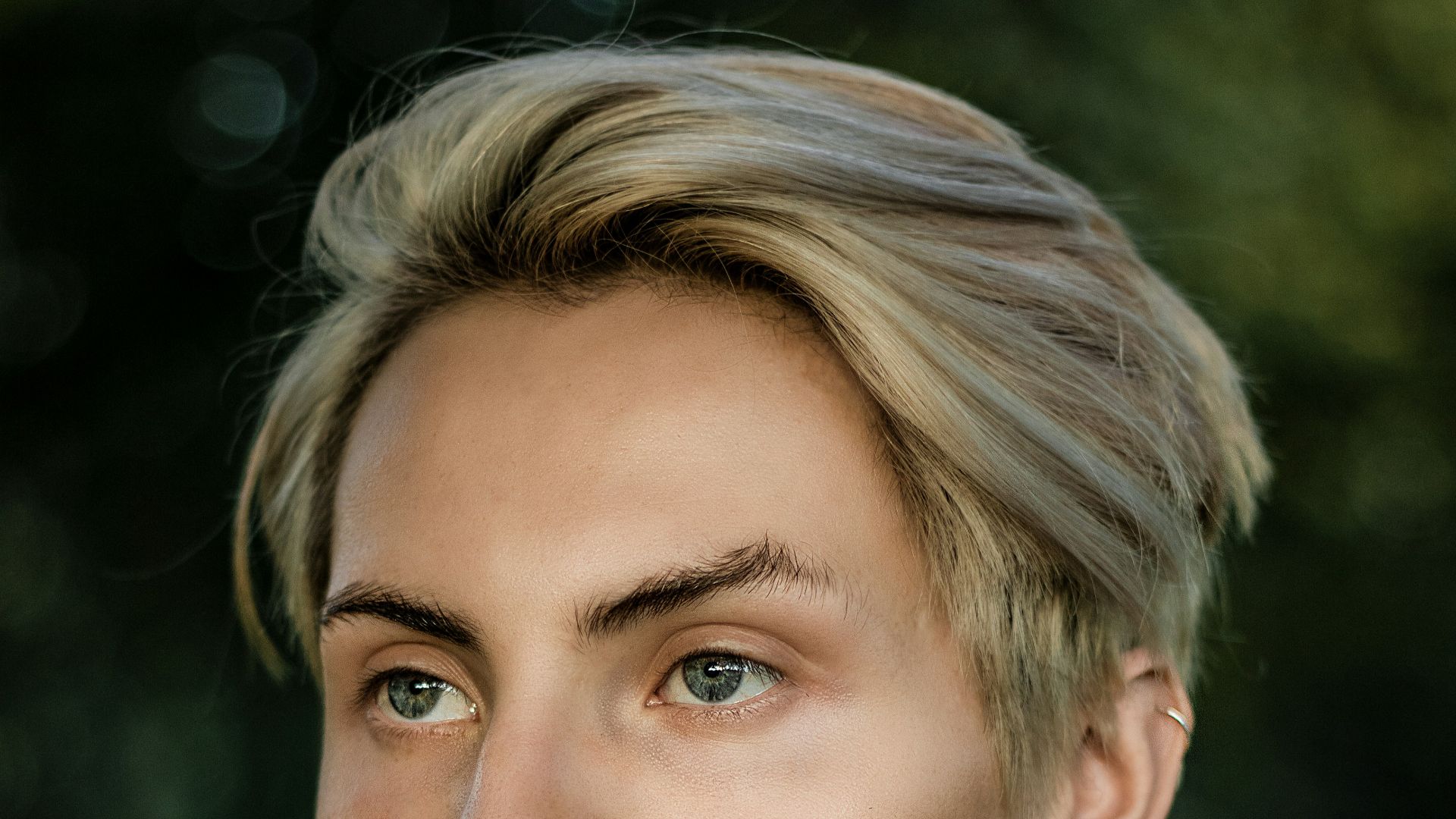 a man with a pearl necklace and a flower in his hand