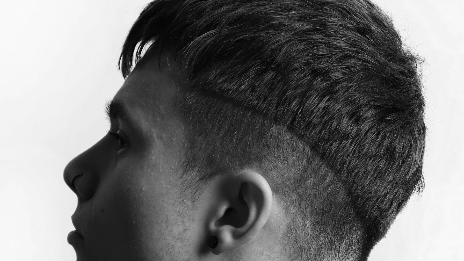 a black and white photo of a young man