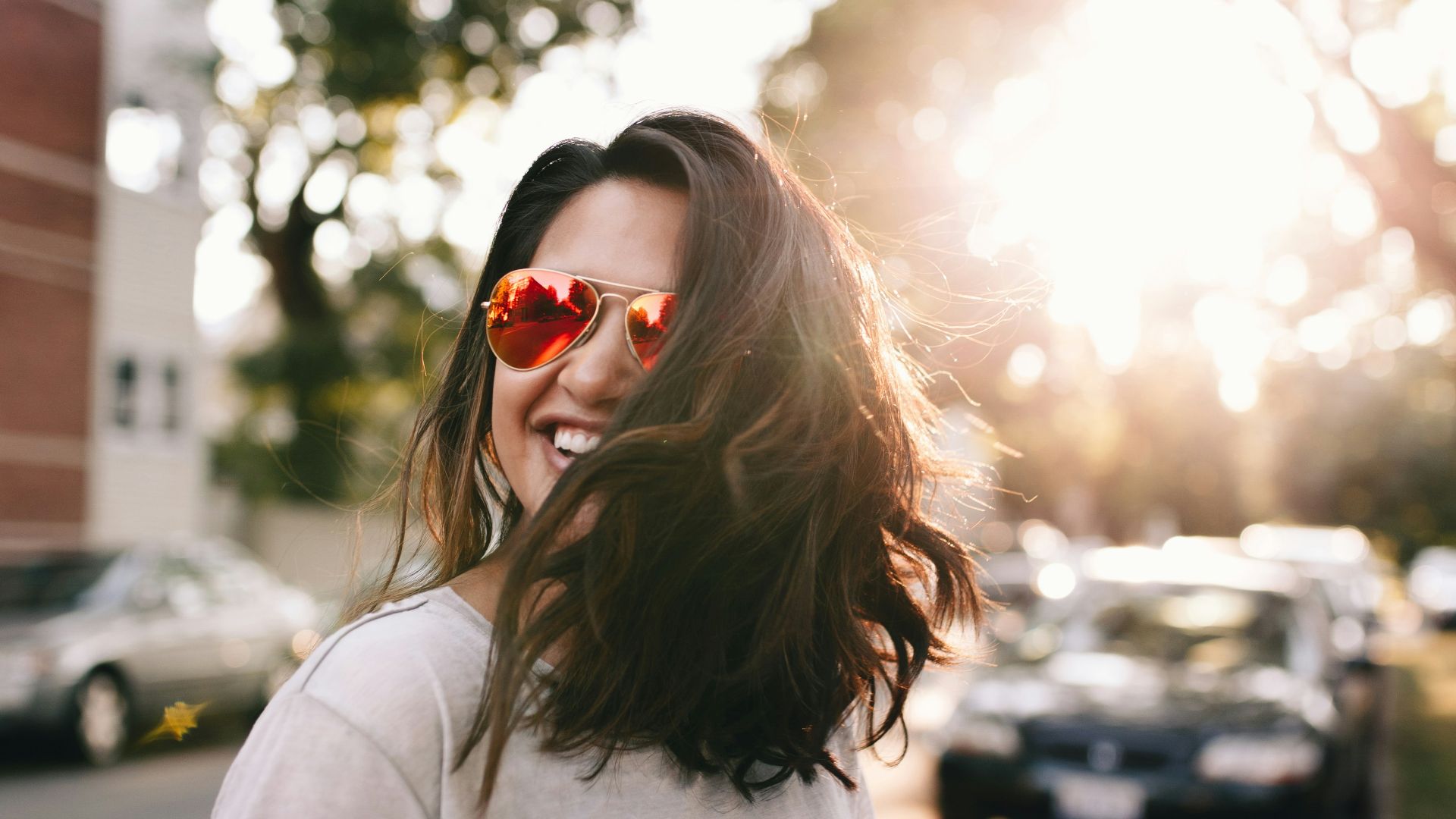 woman wearing white T-shirt smiling