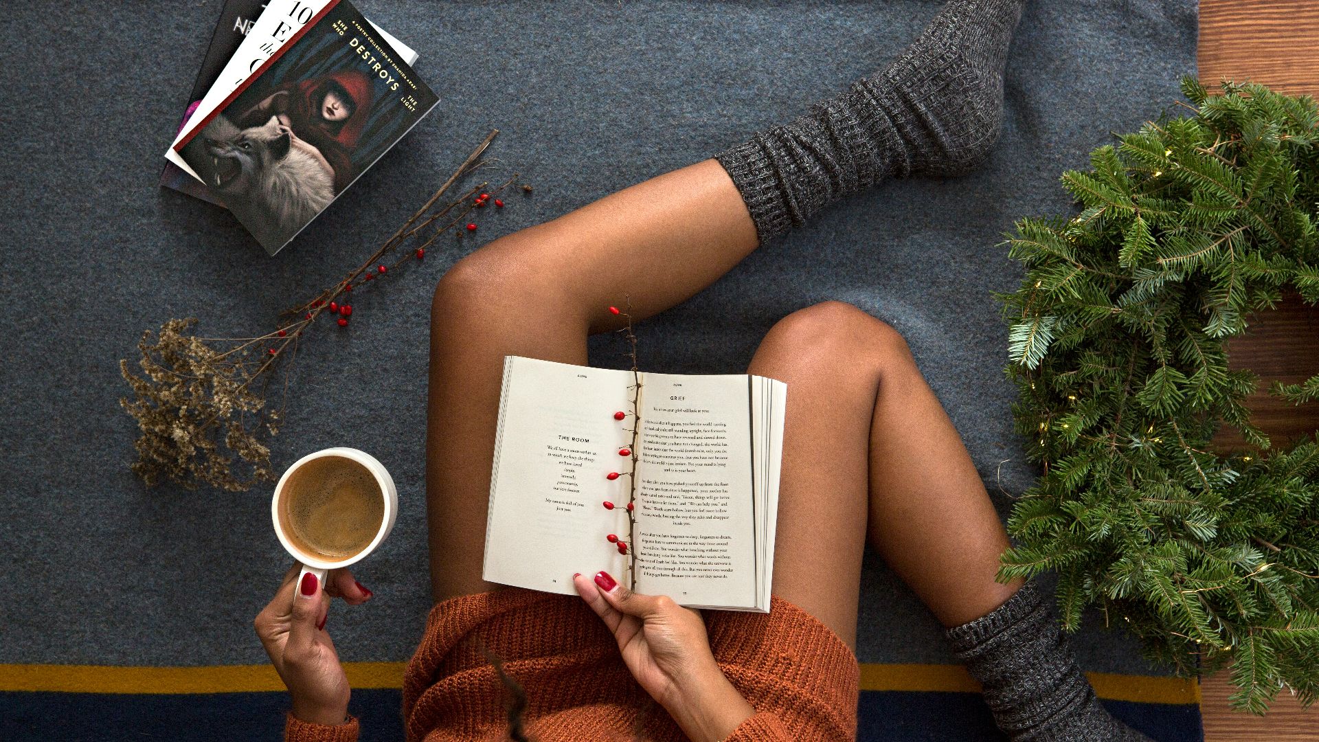 opened book on person's lap with gray socks