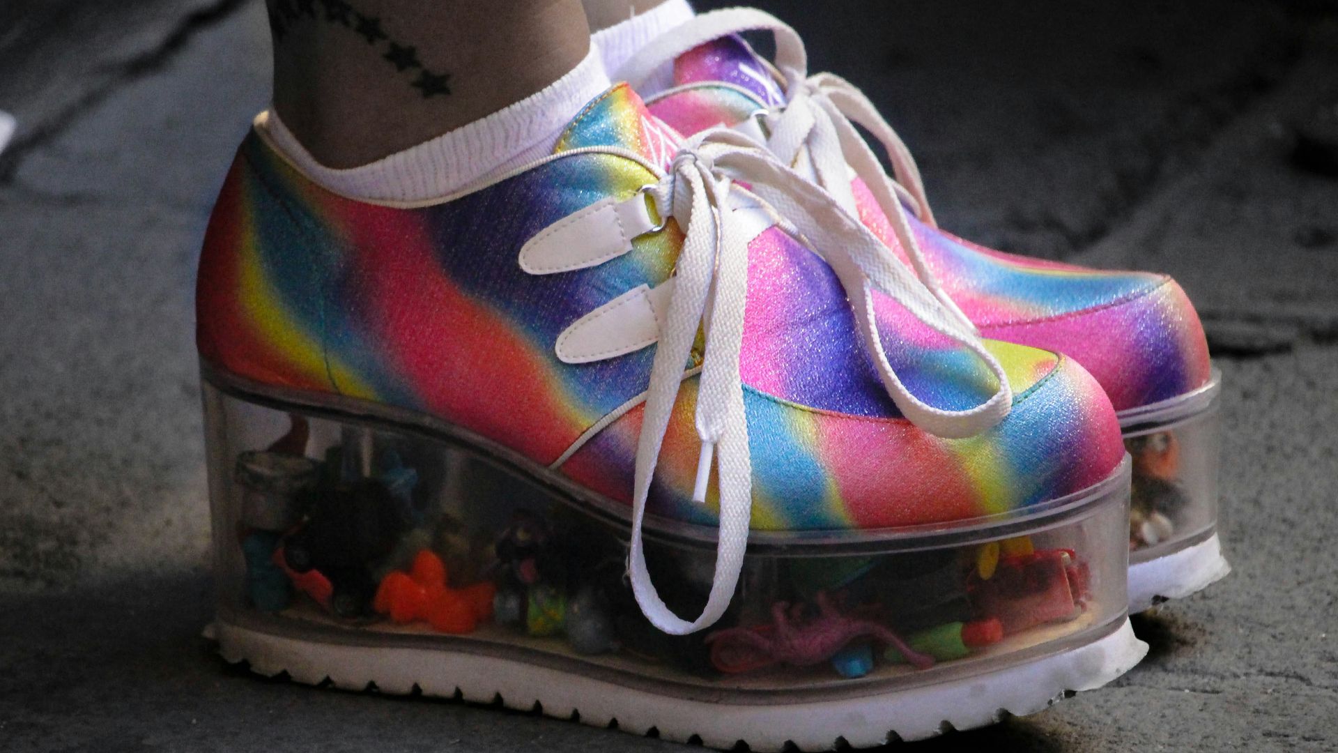 person wearing multicolored wedge shoes