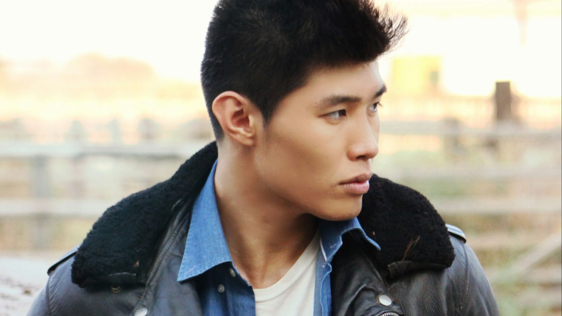 a young man in a black leather jacket