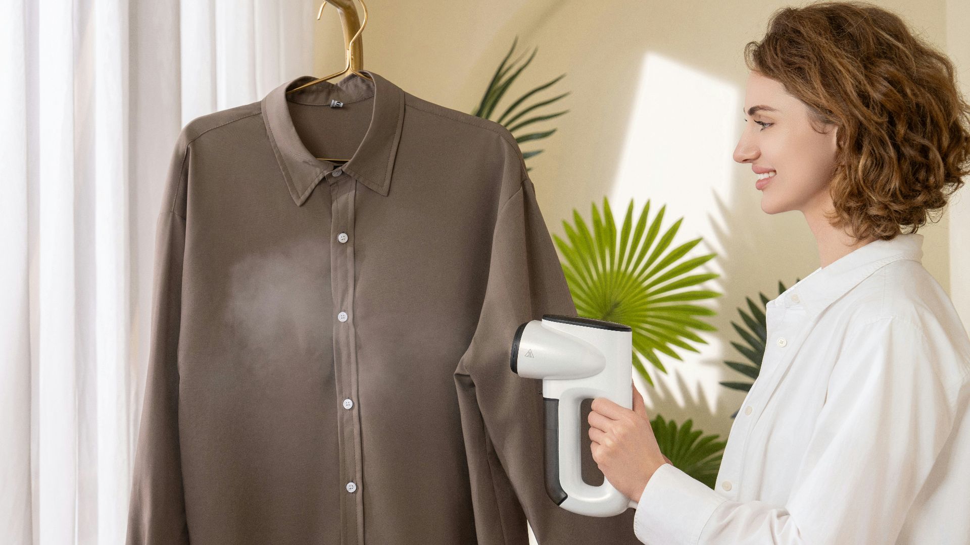 A woman using a hair dryer to dry a shirt