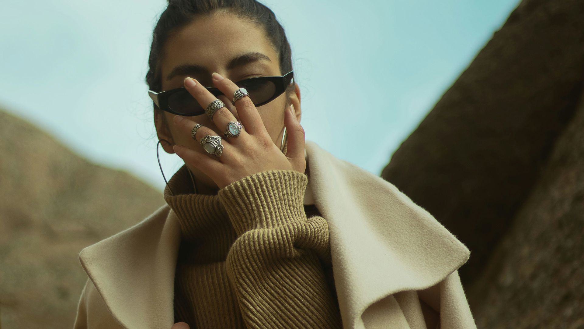 man in brown coat wearing black sunglasses