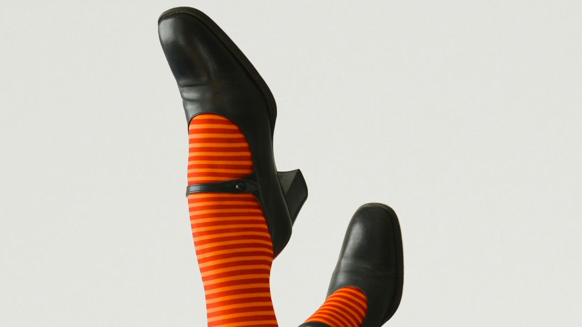 woman wearing pair of black leather chunky-heeled shoes