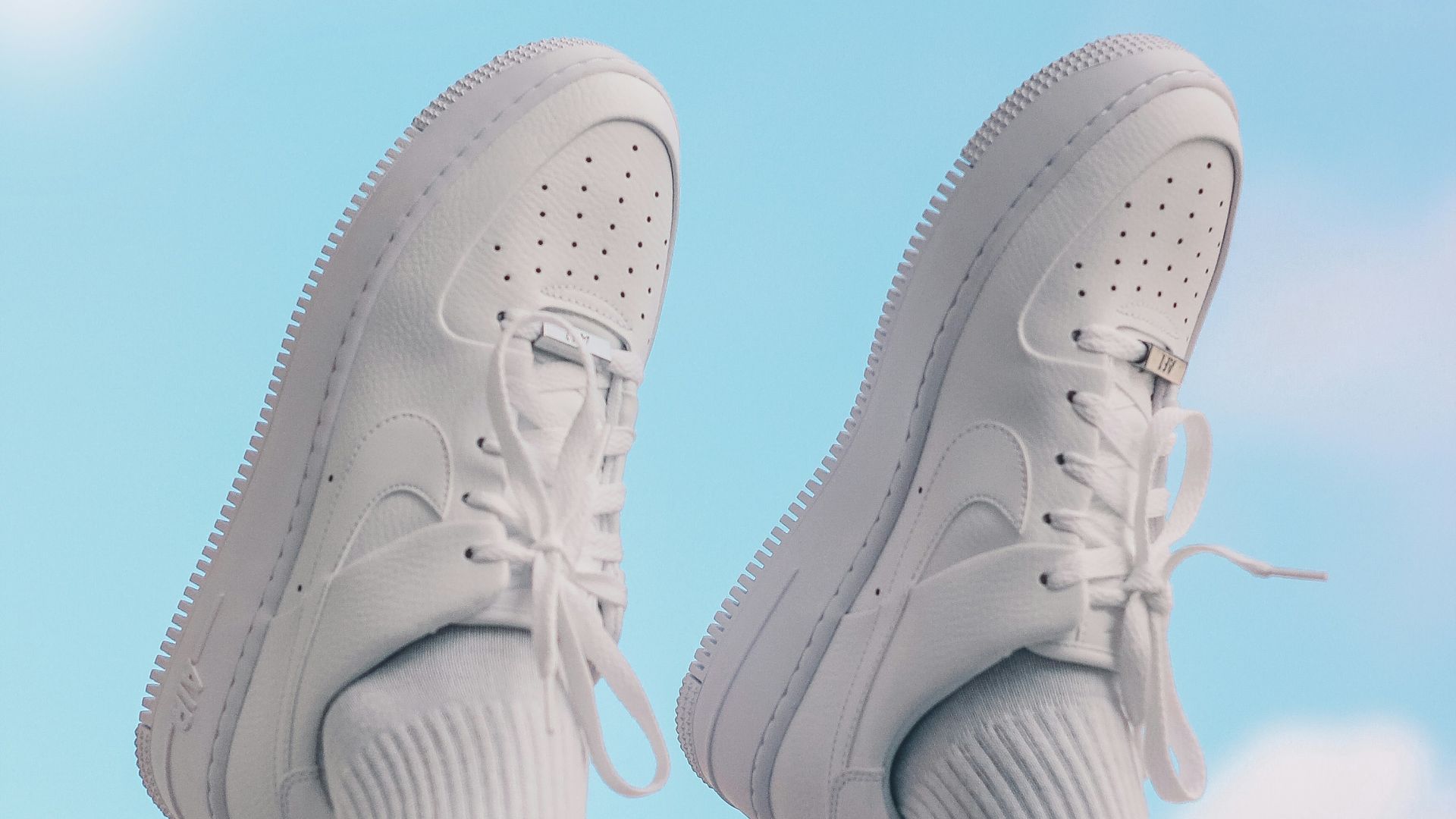 person wearing white nike sneakers