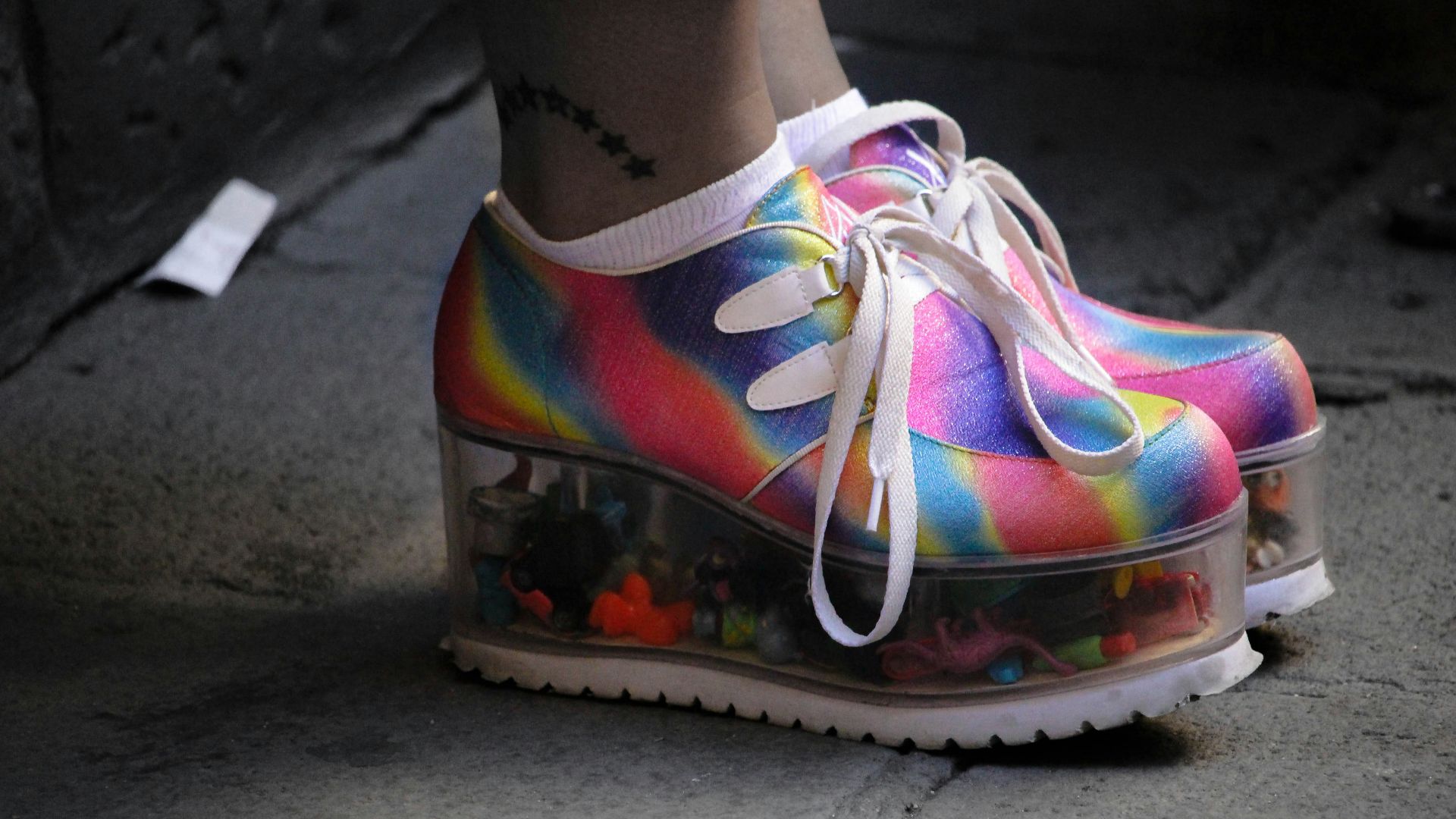 person wearing multicolored wedge shoes