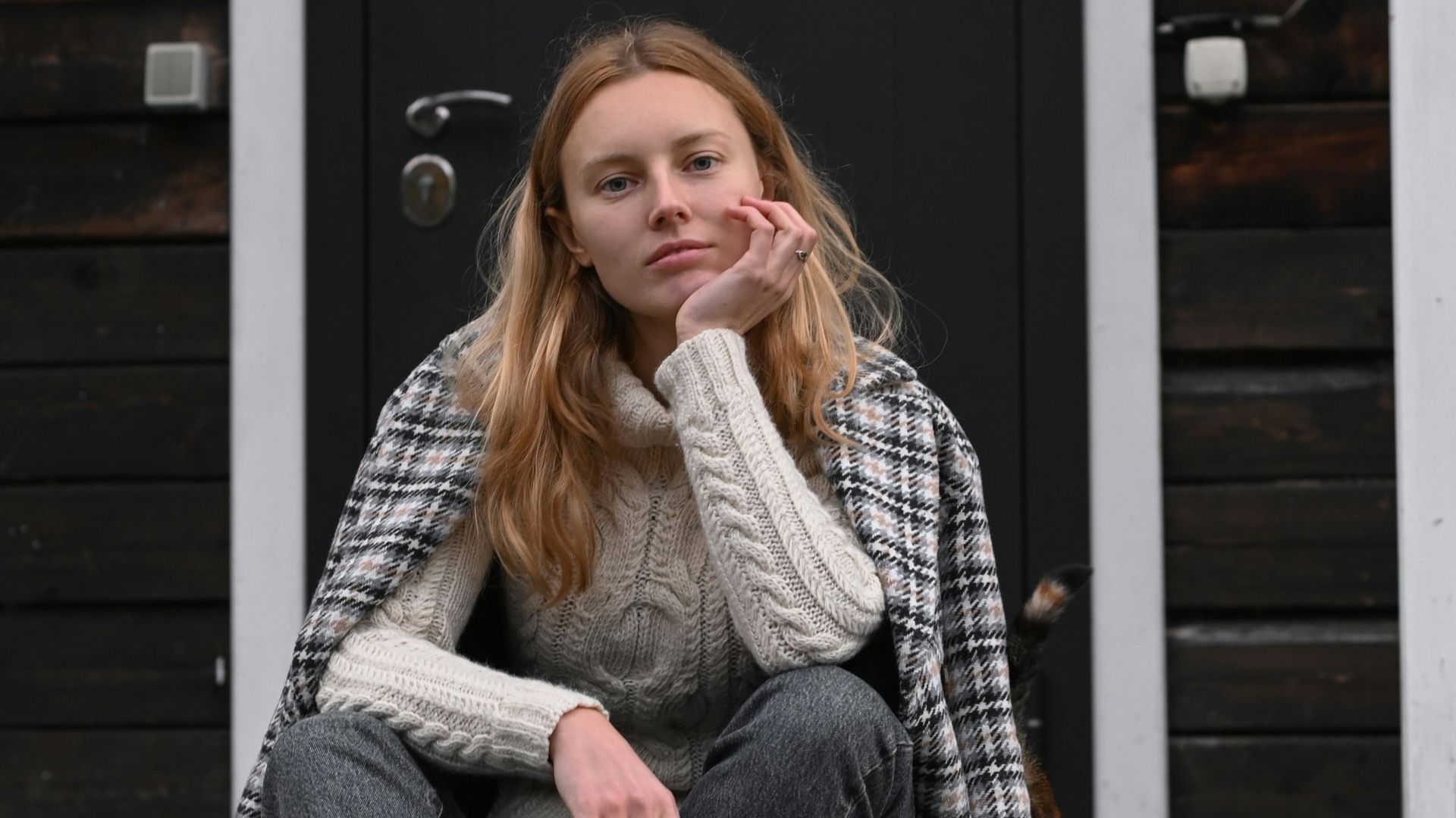 a woman sitting on a porch