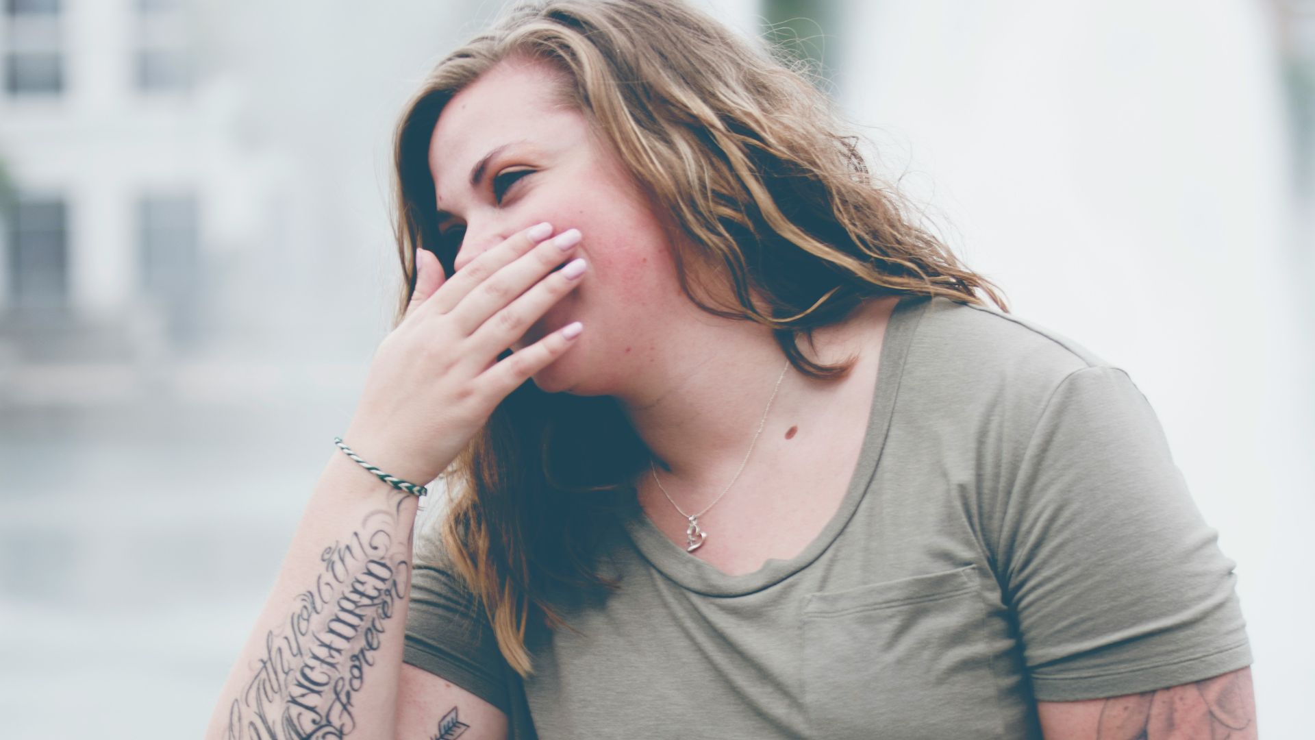 woman covering her mouth