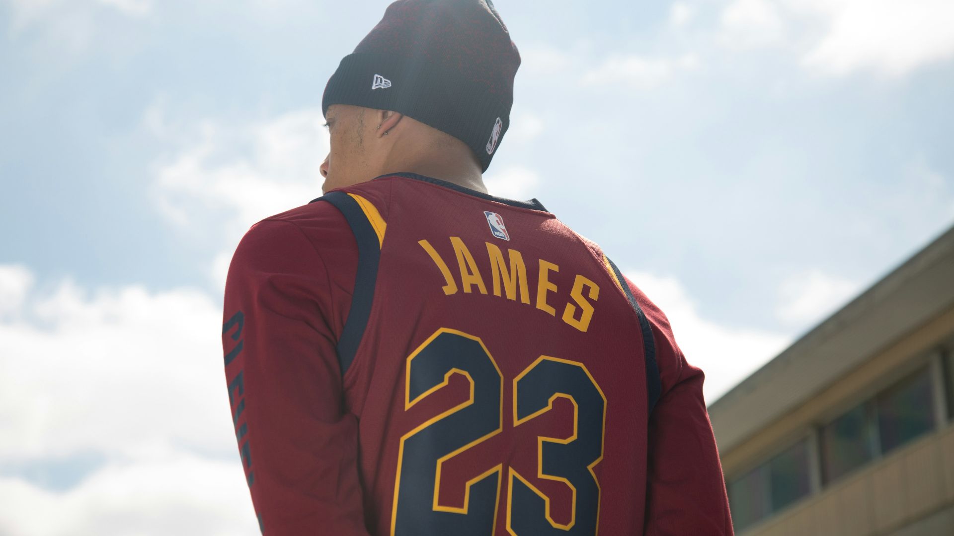 man in black and red long sleeve shirt wearing black cap