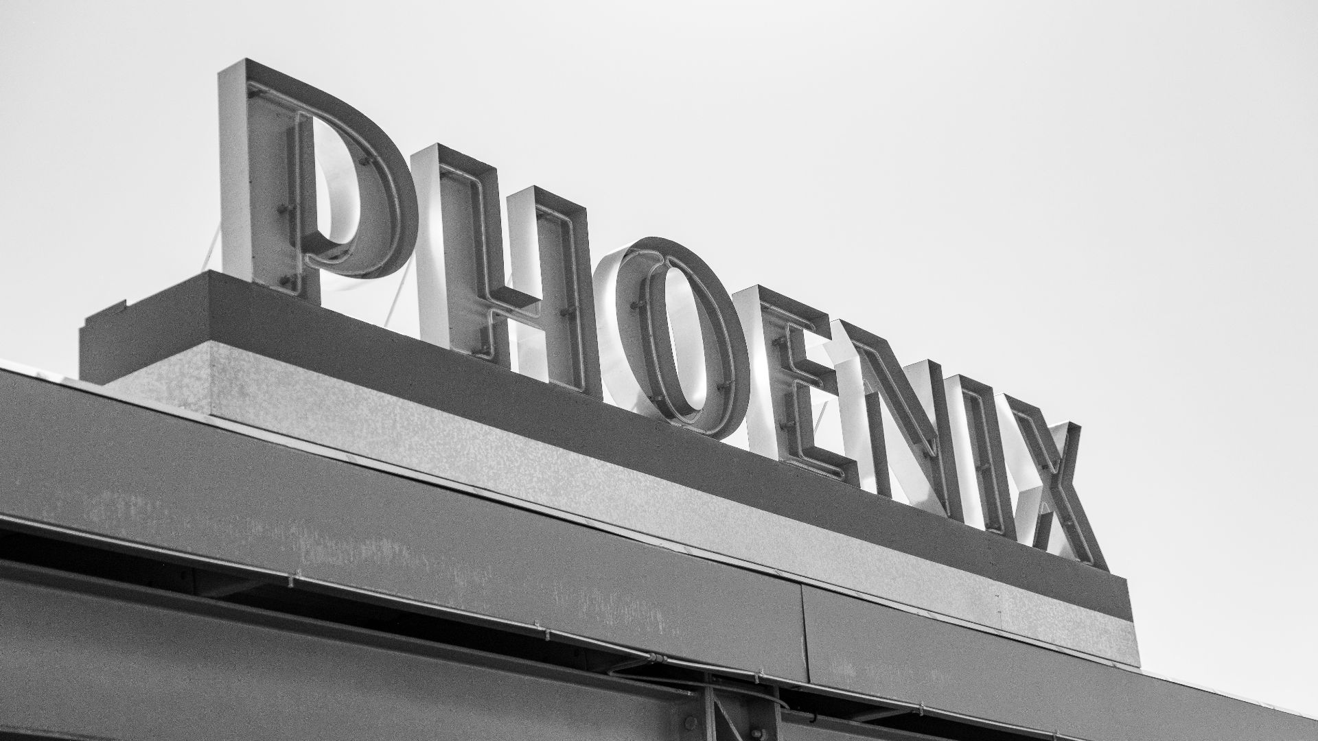 a black and white photo of a sign for a store