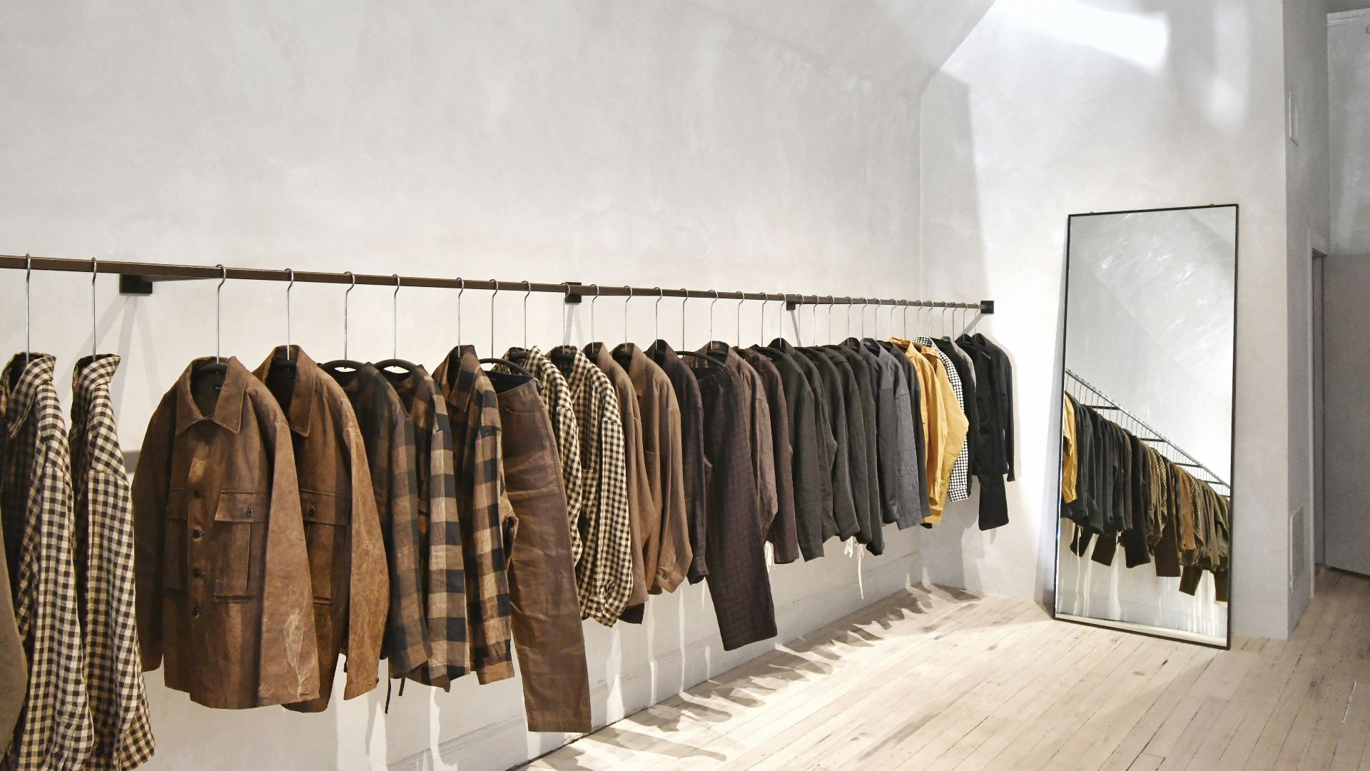 a room with a wall of clothes on the wall