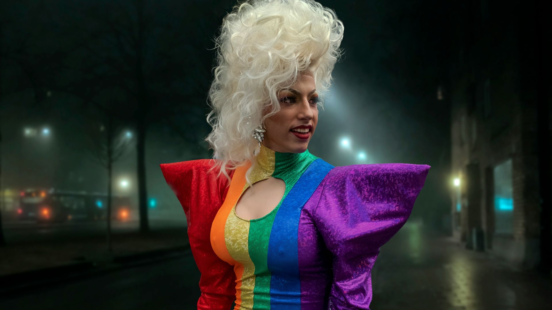 a woman dressed in a rainbow colored outfit