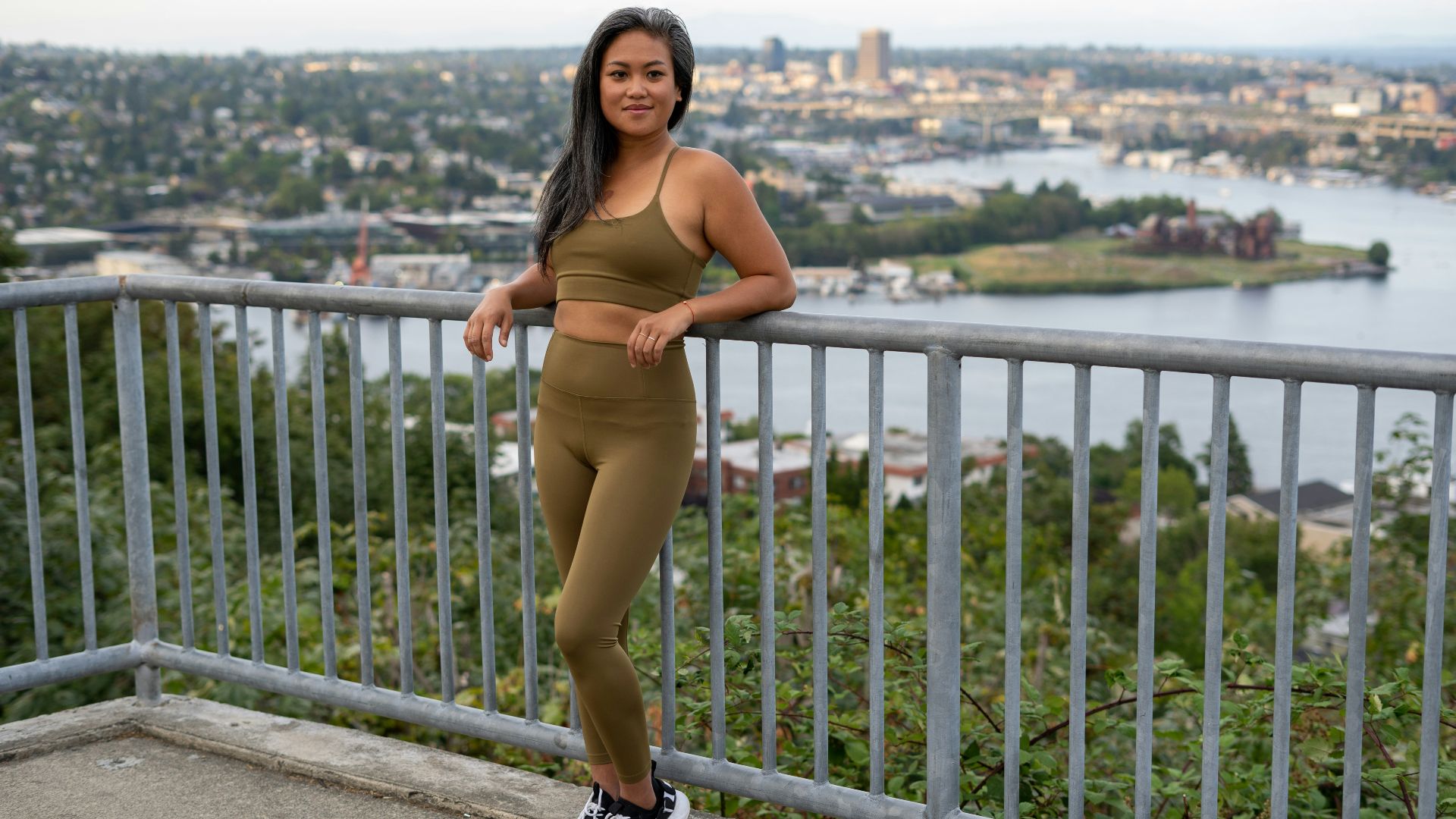 woman in brown bikini standing on gray concrete bridge during daytime